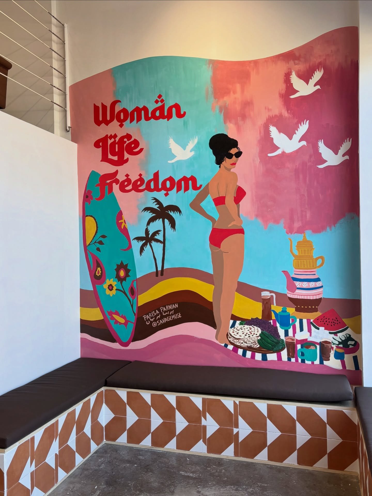 This Woman Life Freedom mural that I painted inside of @caspiancoastcoffee_la is the layered blending of worlds, memories, revolutions, migrations, freedoms won and freedoms lost.

It is holidays at the Caspian Sea with family and friends, breaking s