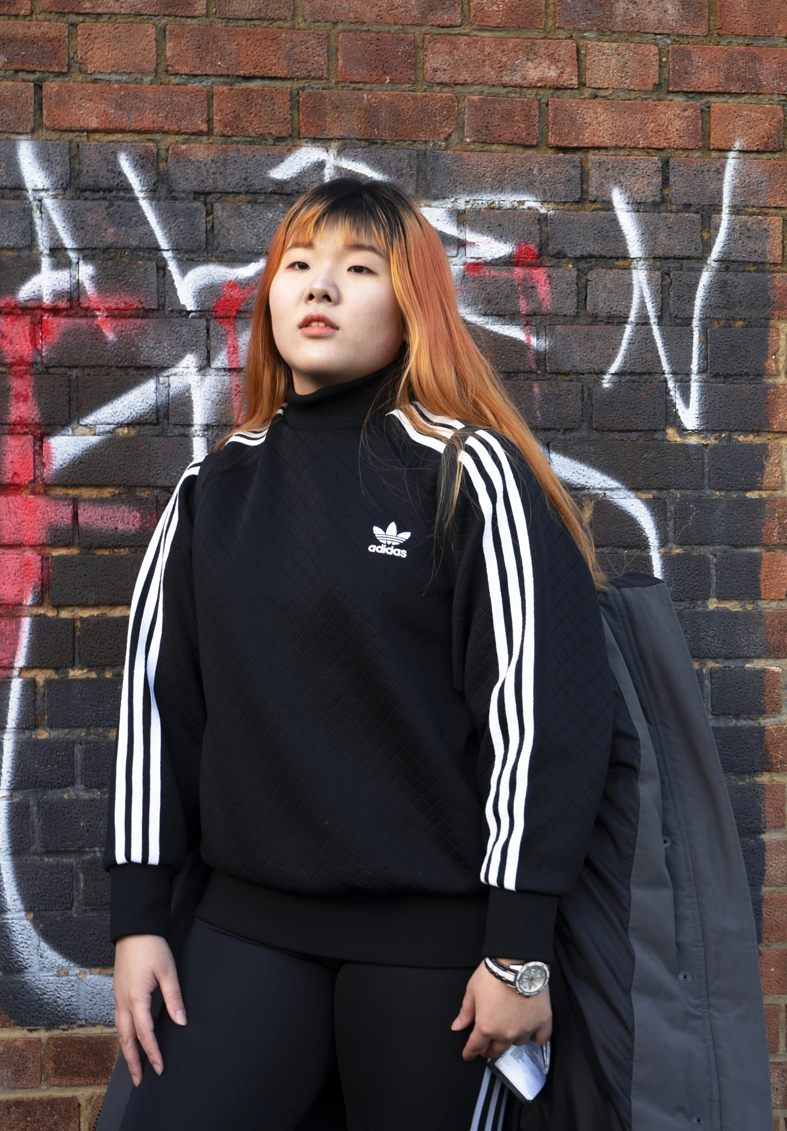 adidas . black . sportswear . fashion shoot . photo shoot . orange hair . Asian female model . wall . photographer in london. photographer in wembley. photographer near me. best photographer in london. headshot photographer. wedding photographer.