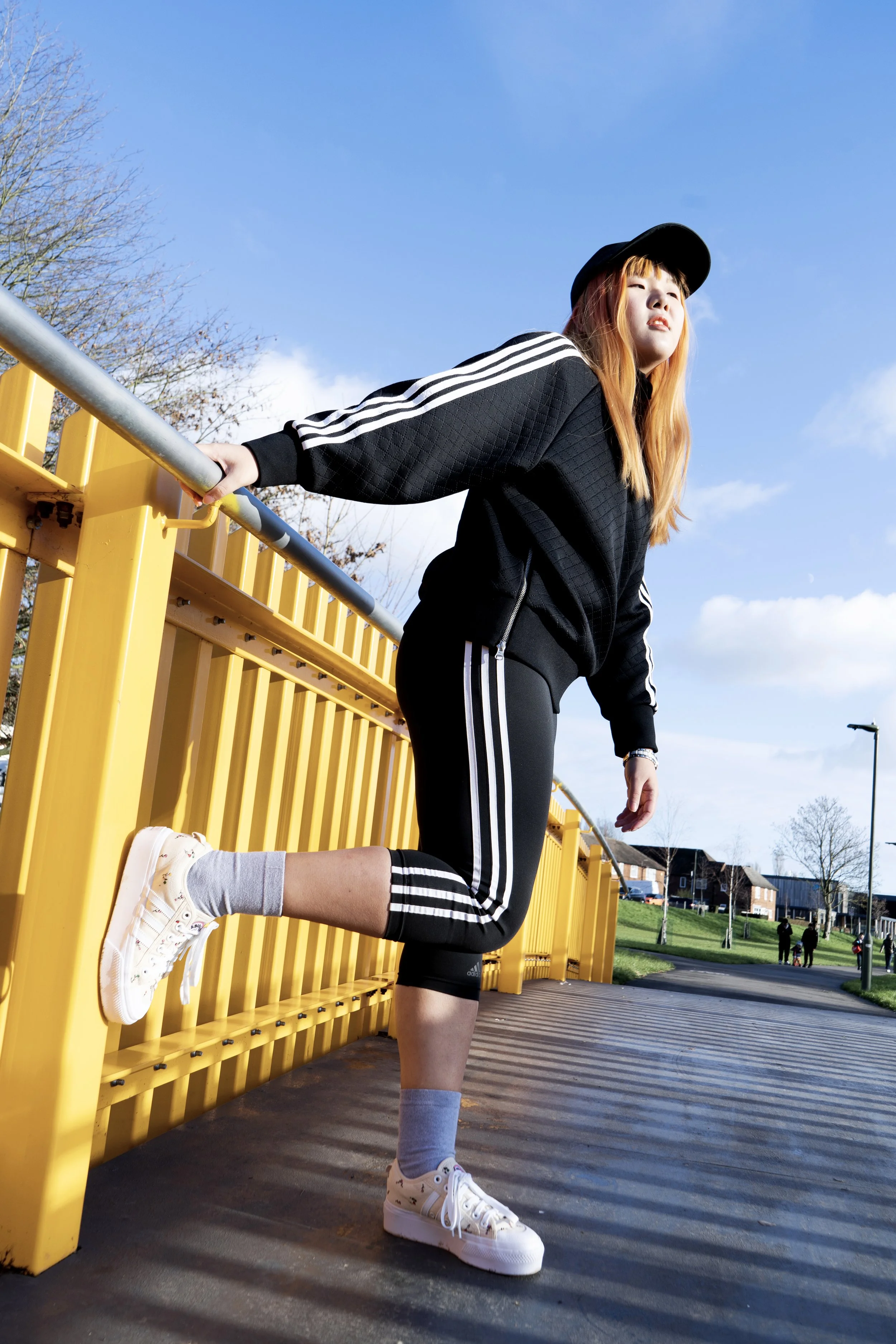 adidas . black . sportswear . fashion shoot . photo shoot . orange hair . Asian female model . yellow . bridge . photographer in london. photographer in wembley. photographer near me. best photographer in london. headshot photographer. wedding photog