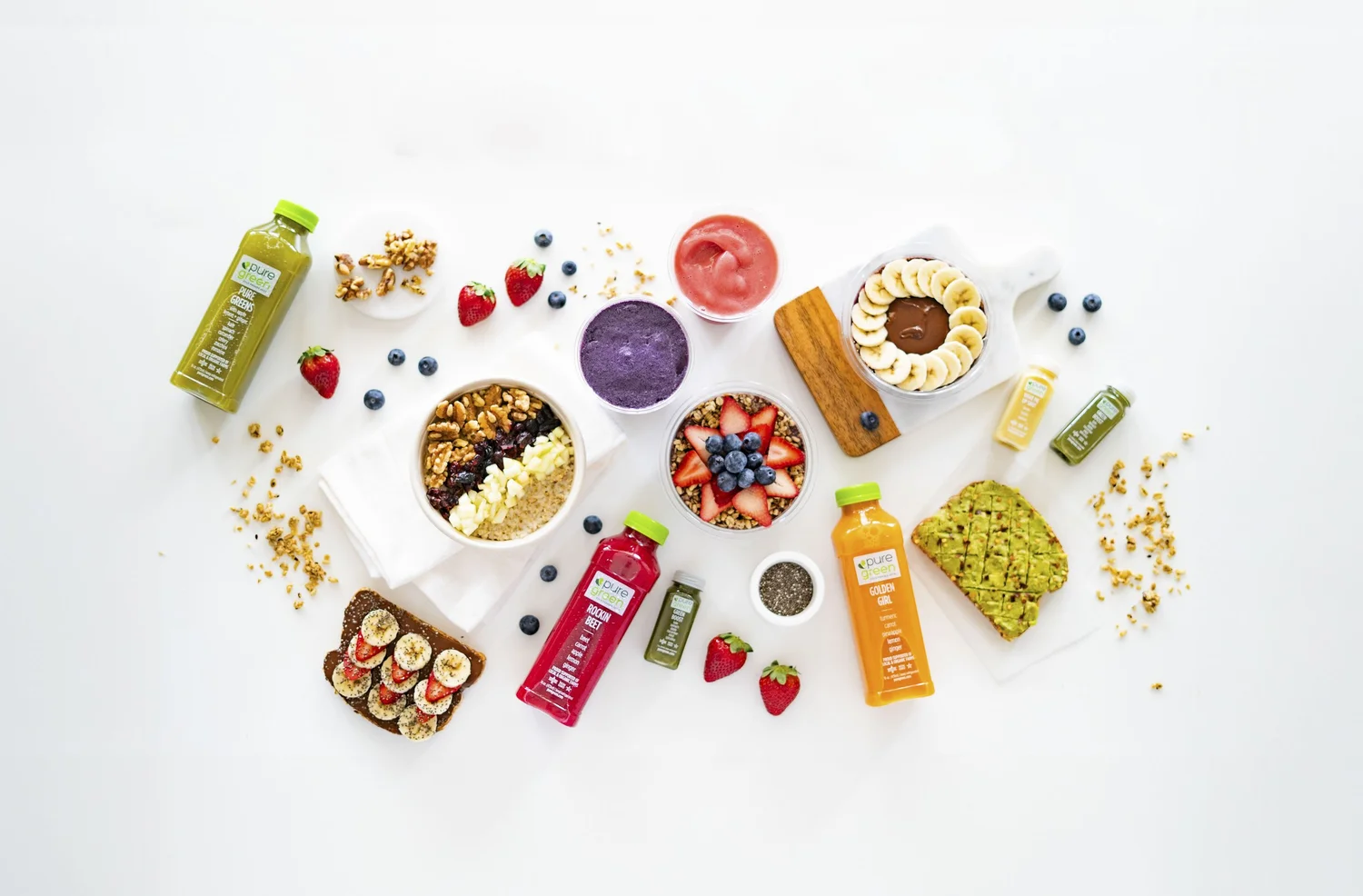 Original Pure Green portfolio photograph of juices, smoothies and food on a white surface