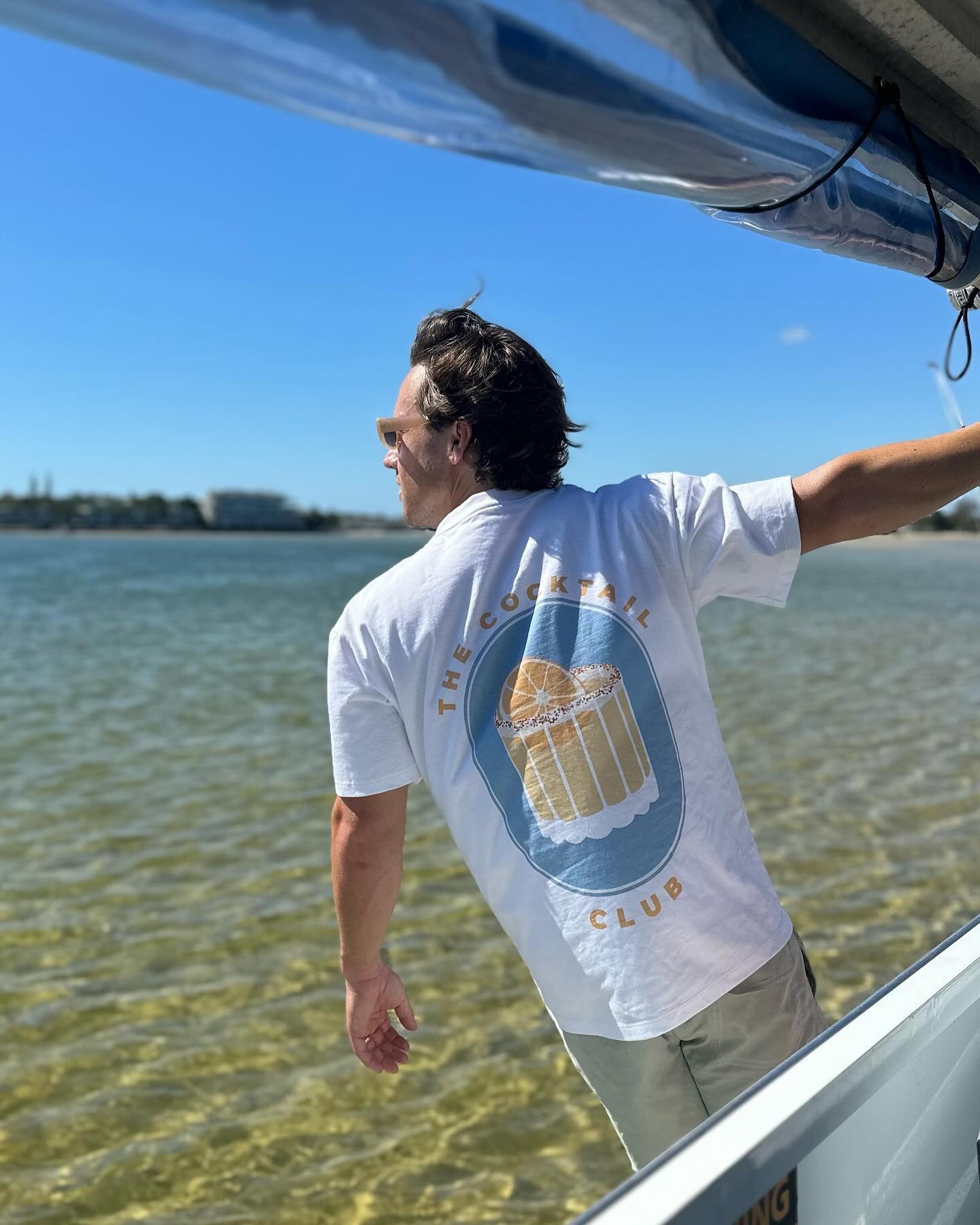 Dreaming of summer days with our Cocktail Club tee. 🌞🌊 Ready for endless sunshine and beachside cheers. Where will you take yours? #SummerDreaming #CocktailClubTees