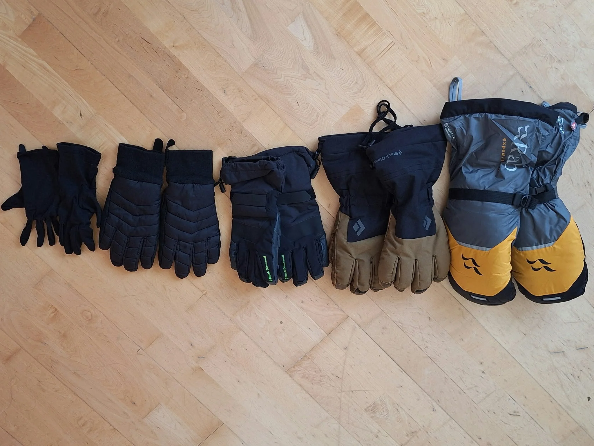 5 sets of gloves of increasing warmth from inners to 8000m expedition mitts