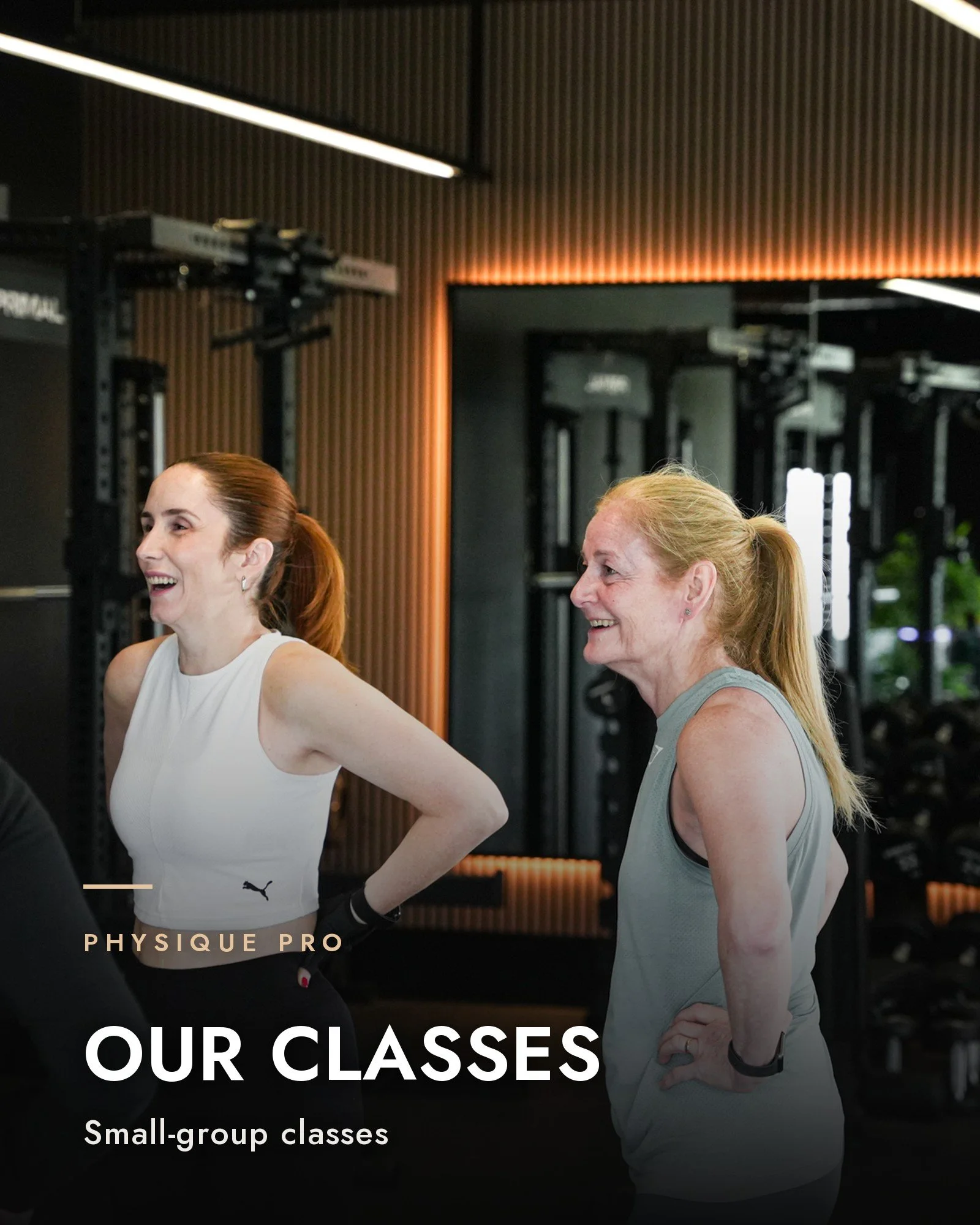 Small group fitness classes at Physique Pro in Newcastle: two members laughing together in the gym