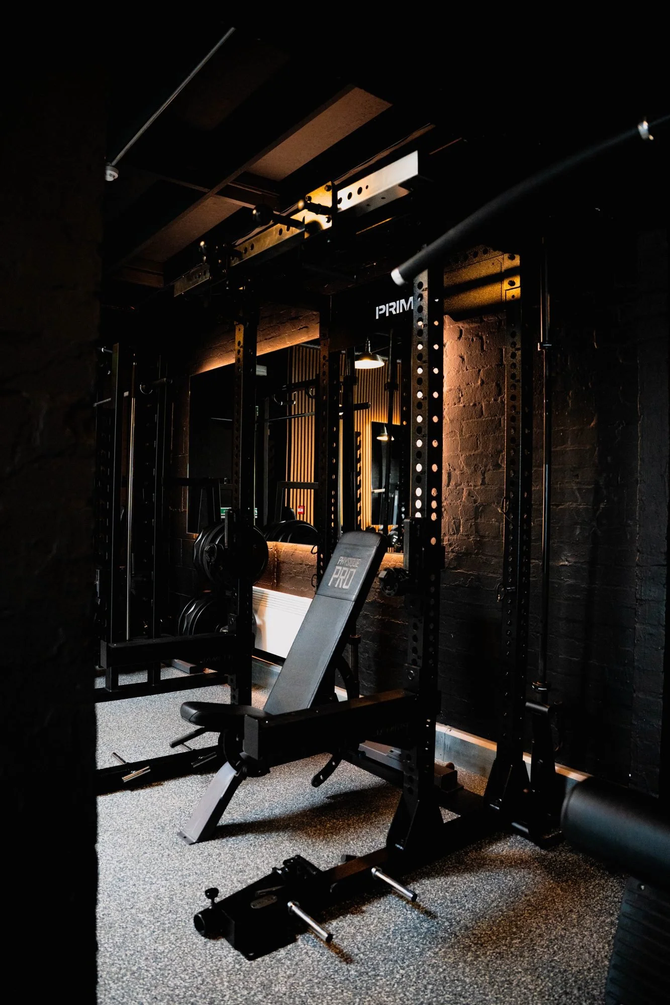Bench and racks in the free-weights area at Physique Pro Gosforth