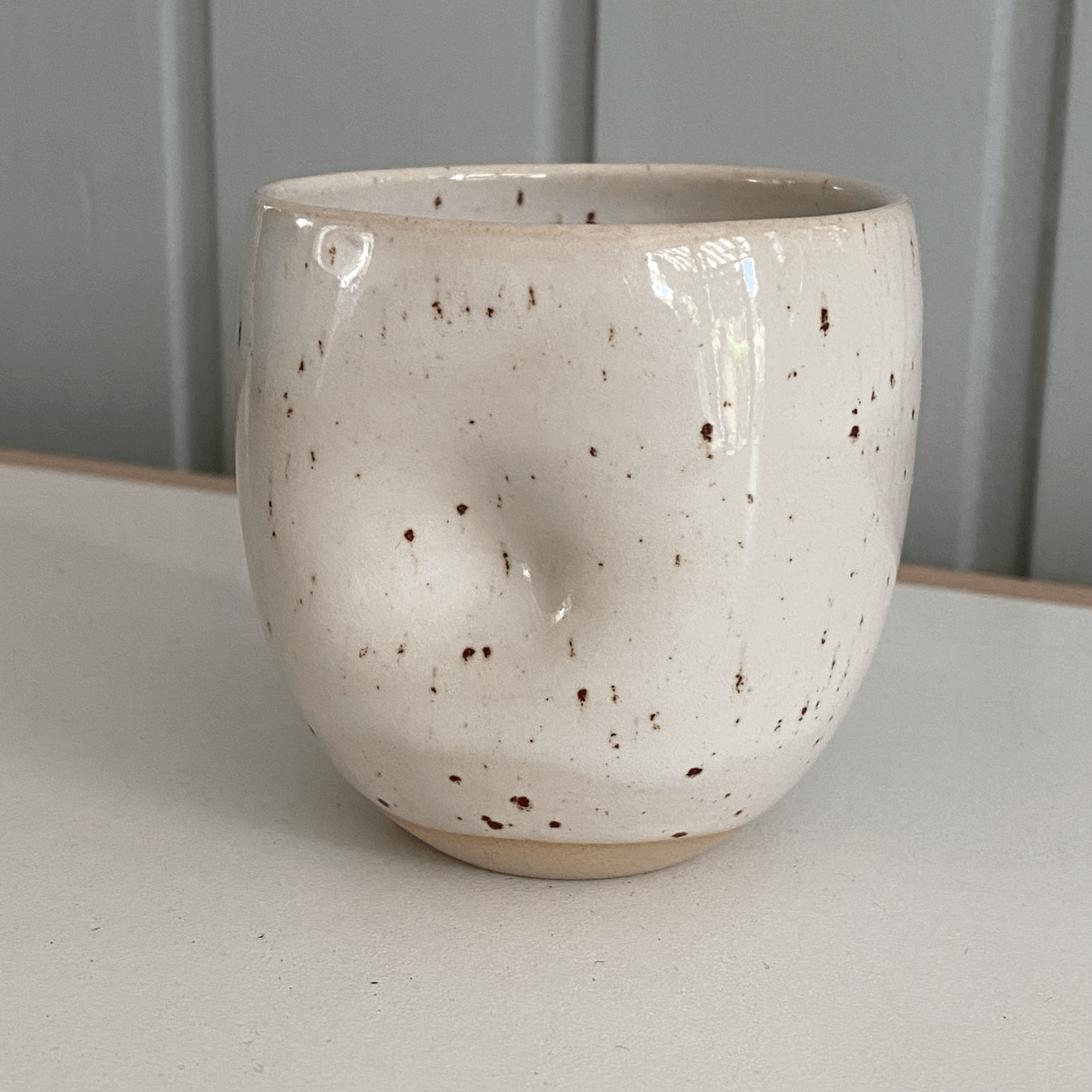 Speckled cup with little dent