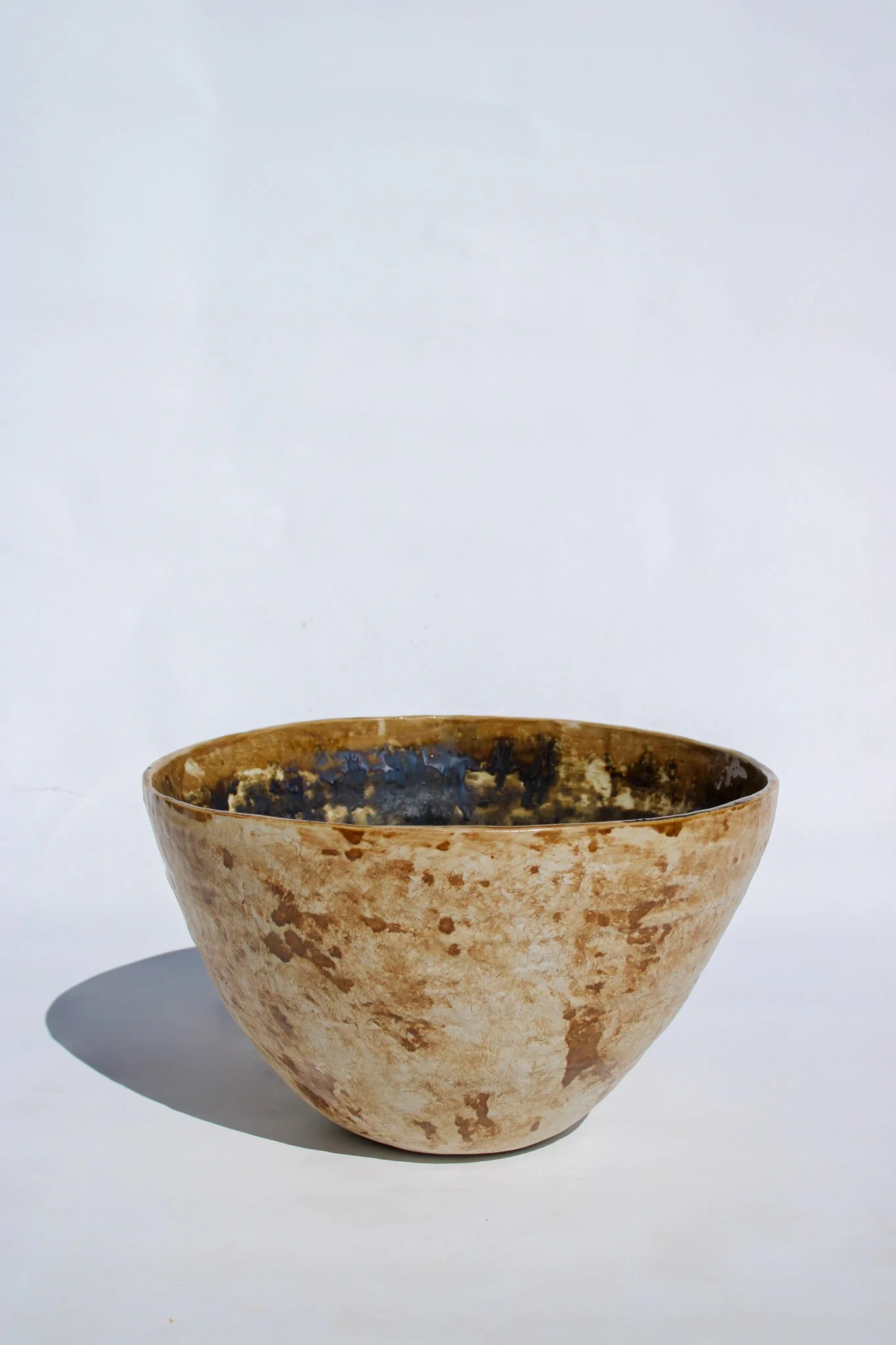 Full view of the IRIDESCENT VESSEL from the Diamond Being Collection of contemporary ceramic works created by Noémie Marmara. An open vessel created from porcelain and stoneware fireclay, containing crystalline glazes, copper and gold.