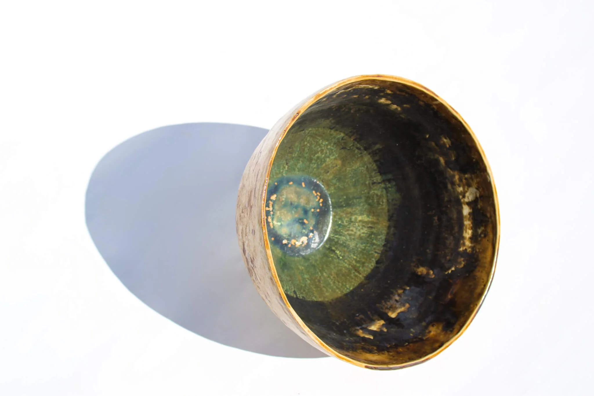 Side view of the IRIDESCENT VESSEL from the Diamond Being Collection of contemporary ceramic works created by Noémie Marmara. An open vessel created from porcelain and stoneware fireclay, containing crystalline glazes, copper and gold.
