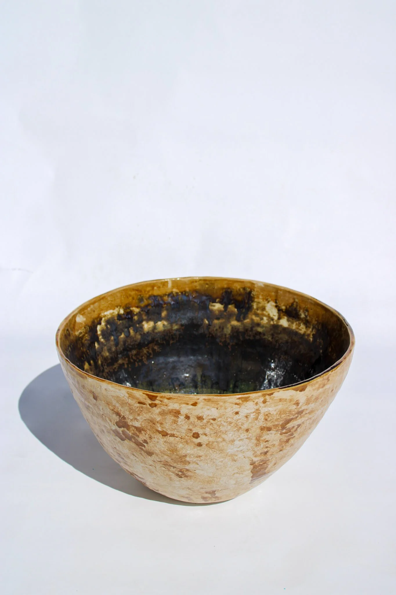 Full view of the IRIDESCENT VESSEL from the Diamond Being Collection of contemporary ceramic works created by Noémie Marmara. An open vessel created from porcelain and stoneware fireclay, containing crystalline glazes, copper and gold.