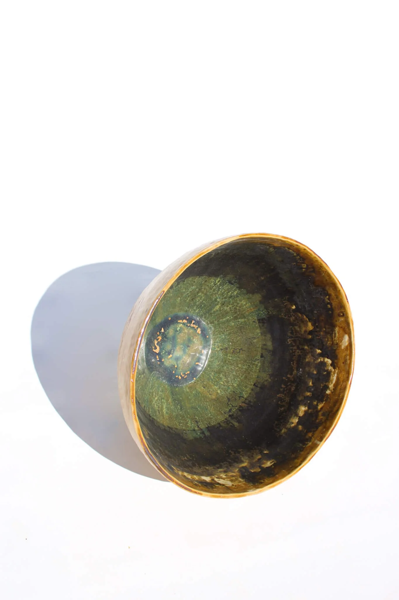 Side view of the IRIDESCENT VESSEL from the Diamond Being Collection of contemporary ceramic works created by Noémie Marmara. An open vessel created from porcelain and stoneware fireclay, containing crystalline glazes, copper and gold.