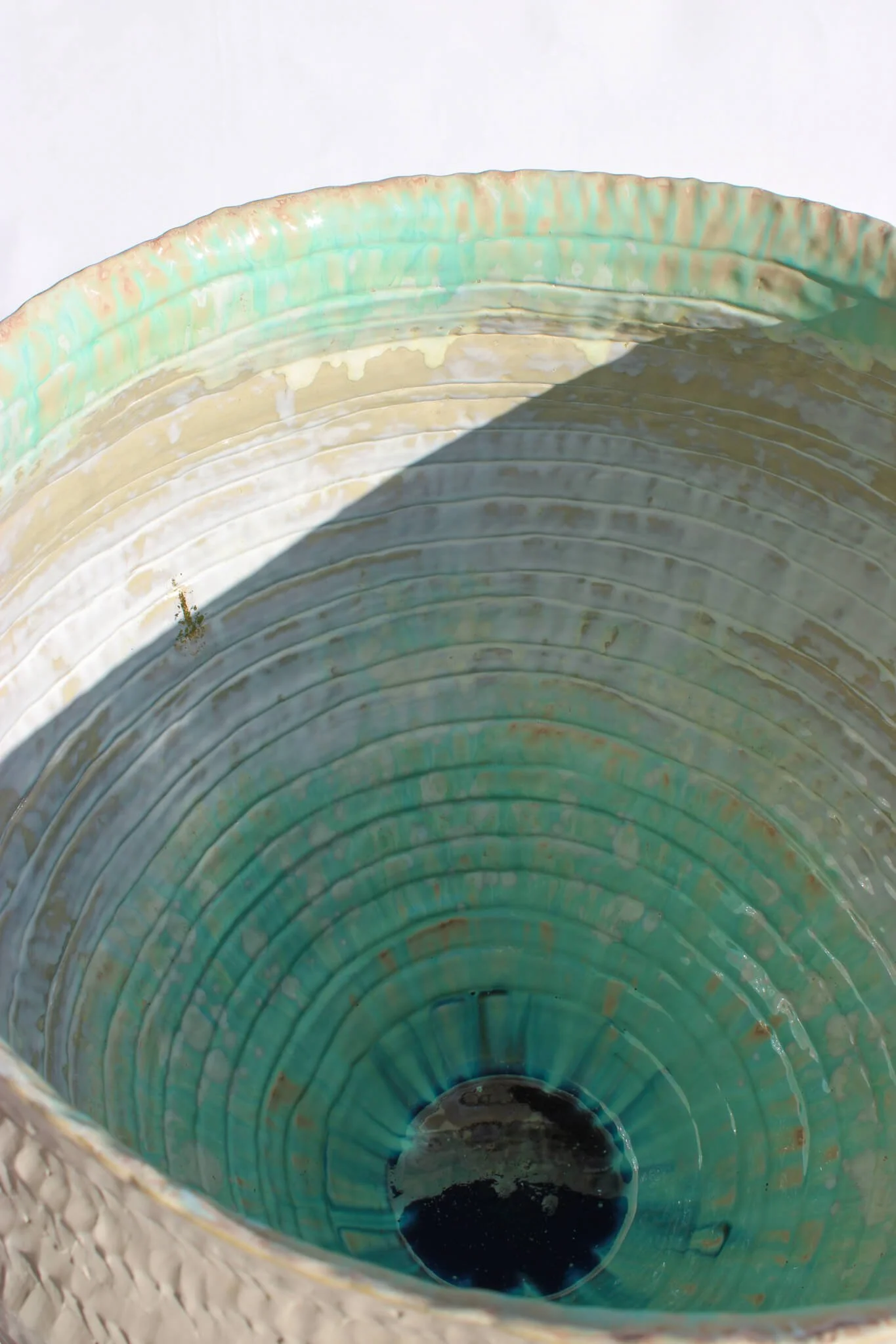 Interior view of the Primordial Vessel: a giant ceramic vessel sculpted out of ivory stoneware clay and containing crystalline glaze by multidisciplinary artist Noemie Marmara