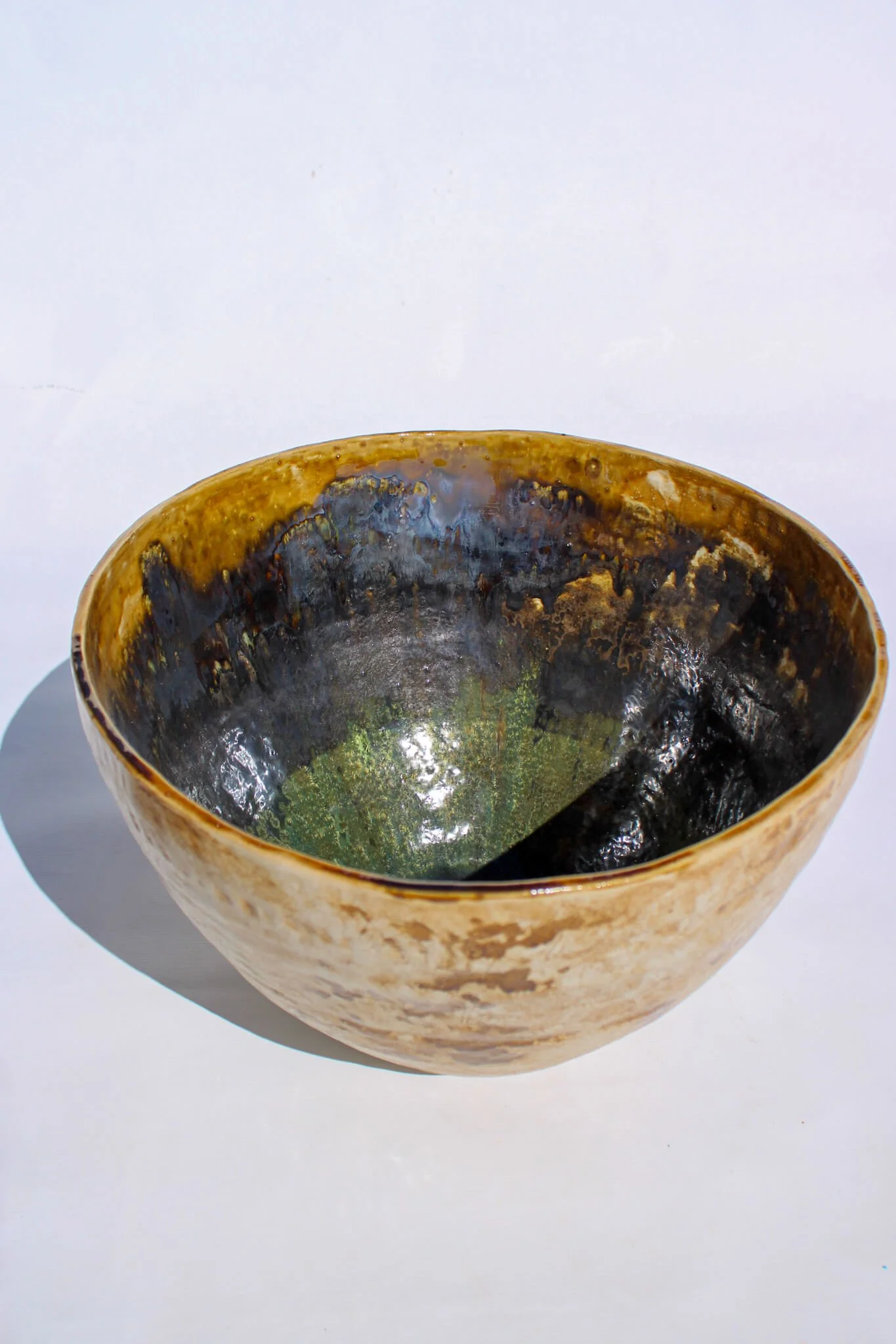 Full view of the IRIDESCENT VESSEL from the Diamond Being Collection of contemporary ceramic works created by Noémie Marmara. An open vessel created from porcelain and stoneware fireclay, containing crystalline glazes, copper and gold.