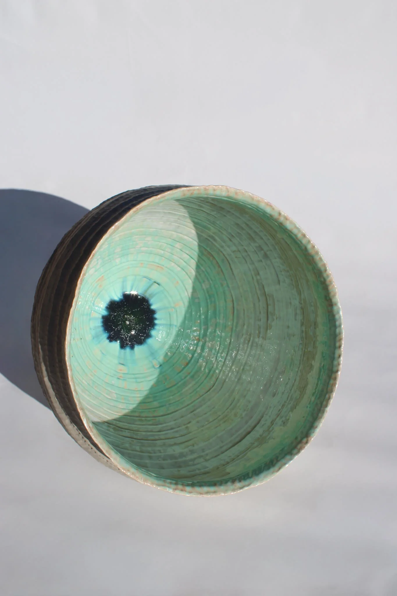 Interior view of the Primordial Vessel: a giant ceramic vessel sculpted out of ivory stoneware clay and containing crystalline glaze by multidisciplinary artist Noemie Marmara