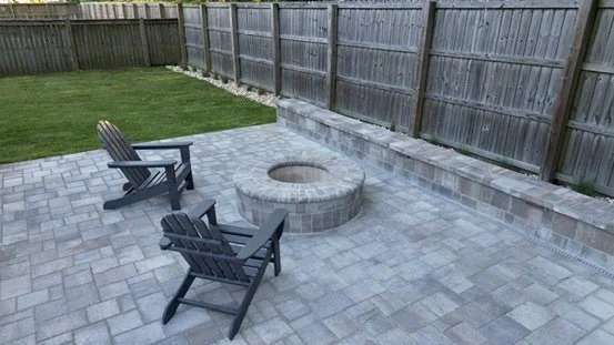 Modern backyard patio featuring a cozy fire pit and relaxing seating.
