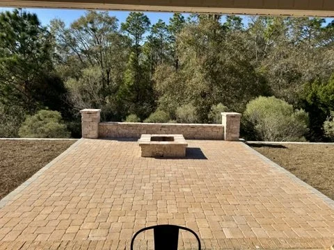 Outdoor firepit area with paver patio, surrounded by scenic natural views.