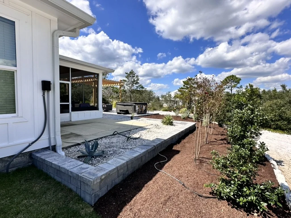 Modern landscaping design with vibrant plants, clean stonework, and lush outdoor aesthetics.