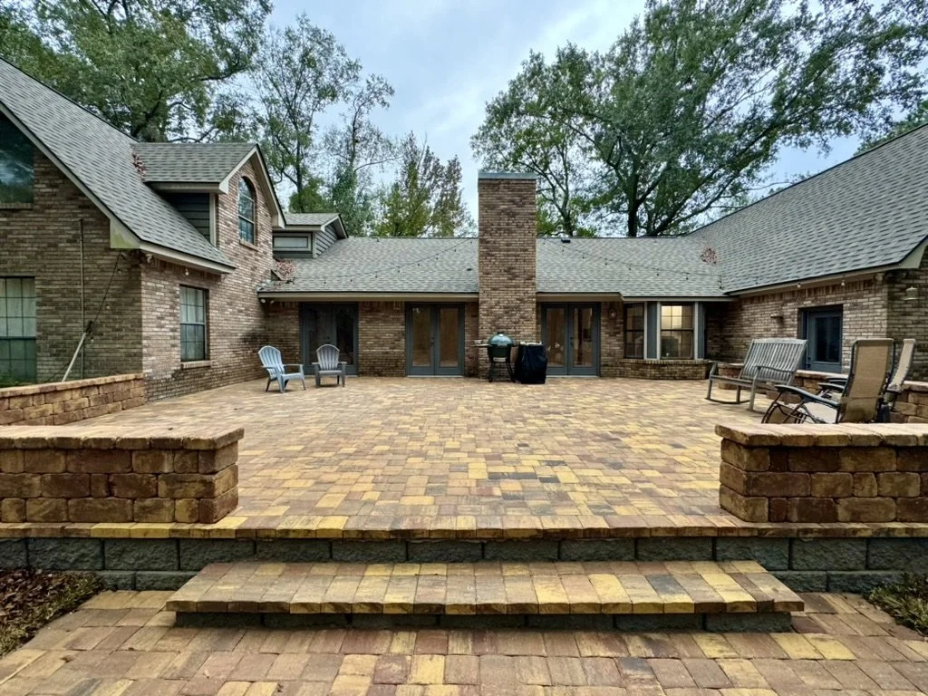 Massive paver patio with steps, perfect for outdoor gatherings at a stylish home.