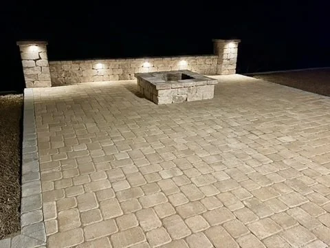 Elegant fire pit patio with soft lighting for serene evening gatherings.