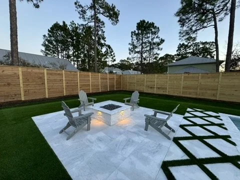 Cozy fire pit seating area surrounded by lush turf, ideal for relaxing evenings.