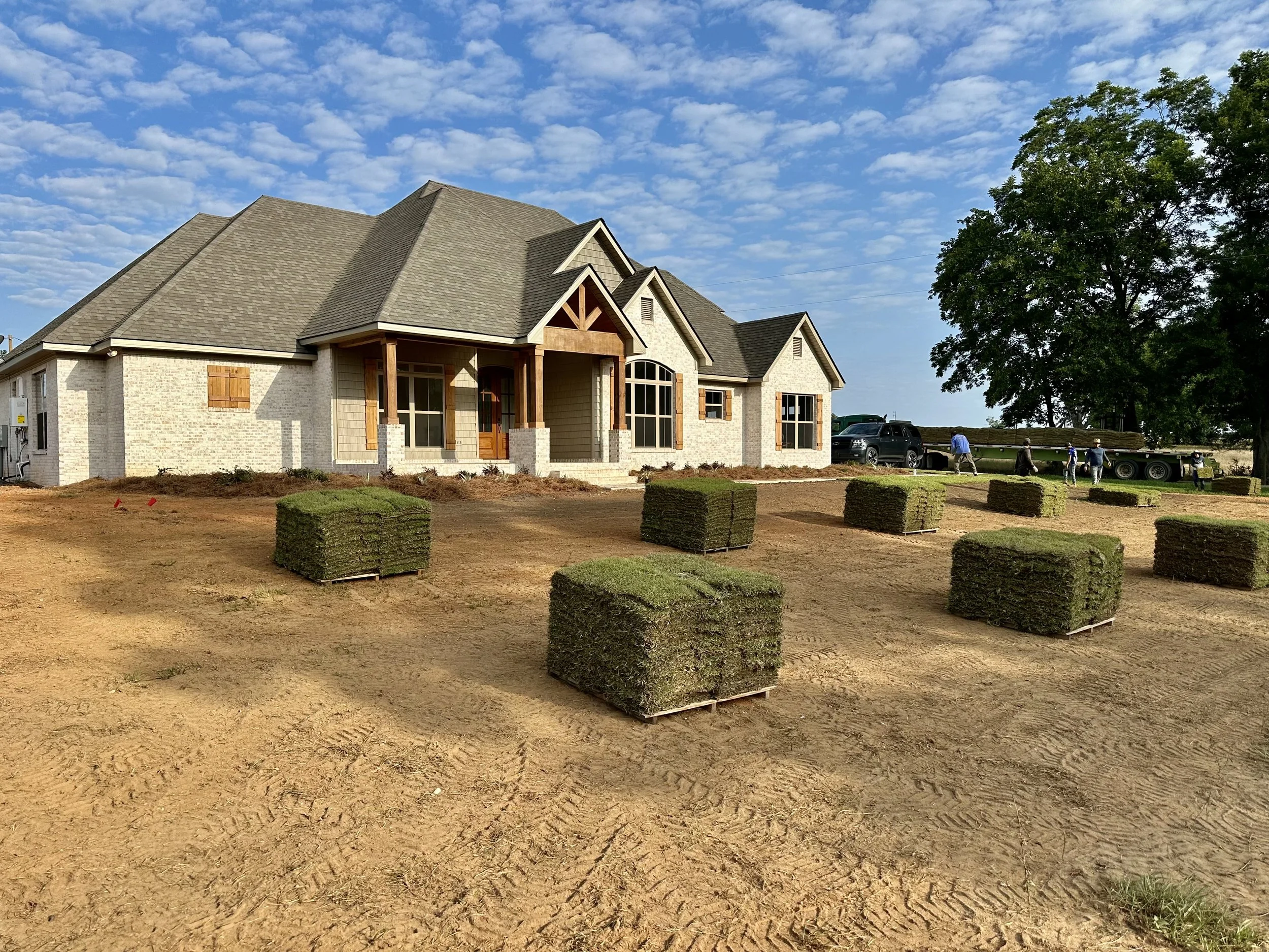 Preparation for sod installation in the front yard of a new home.