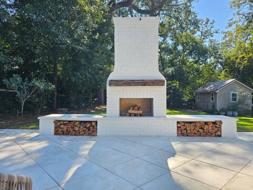 Outdoor brick fireplace with integrated wood storage for warmth and style.