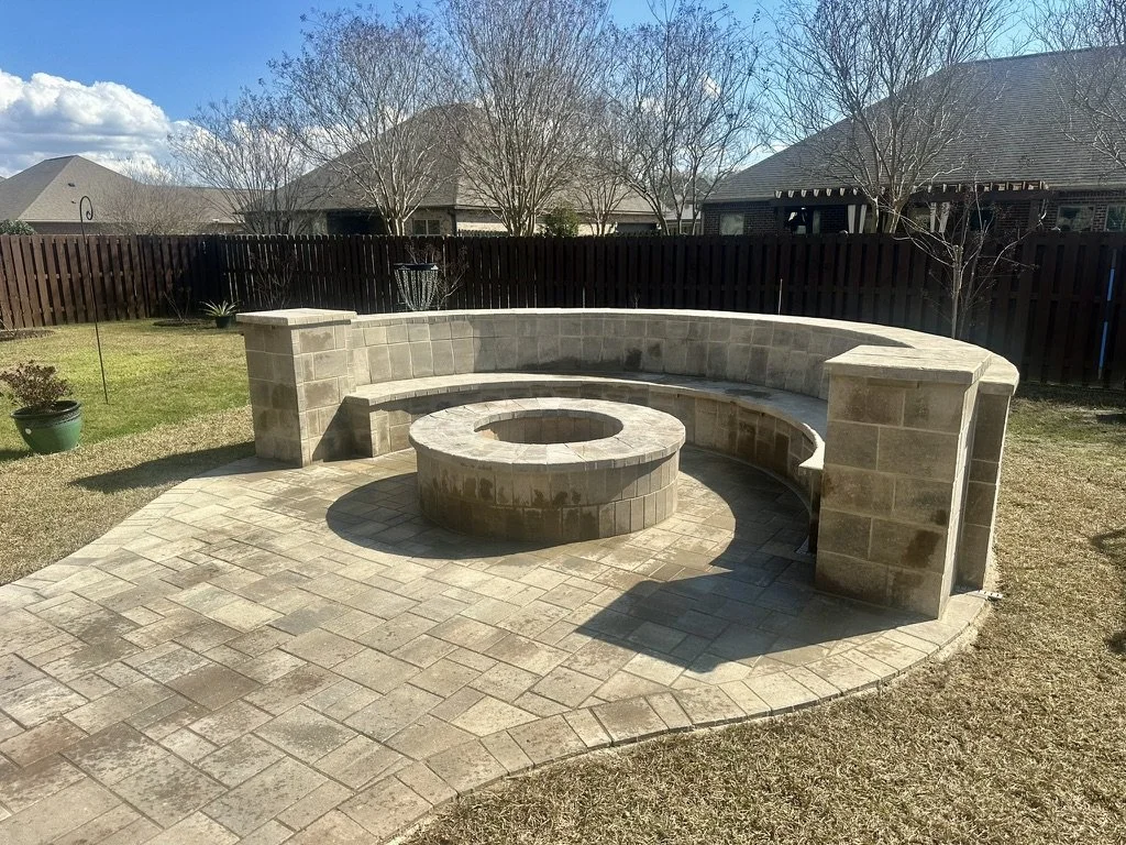 Stylish curved stone bench surrounding a fire pit for family gatherings.