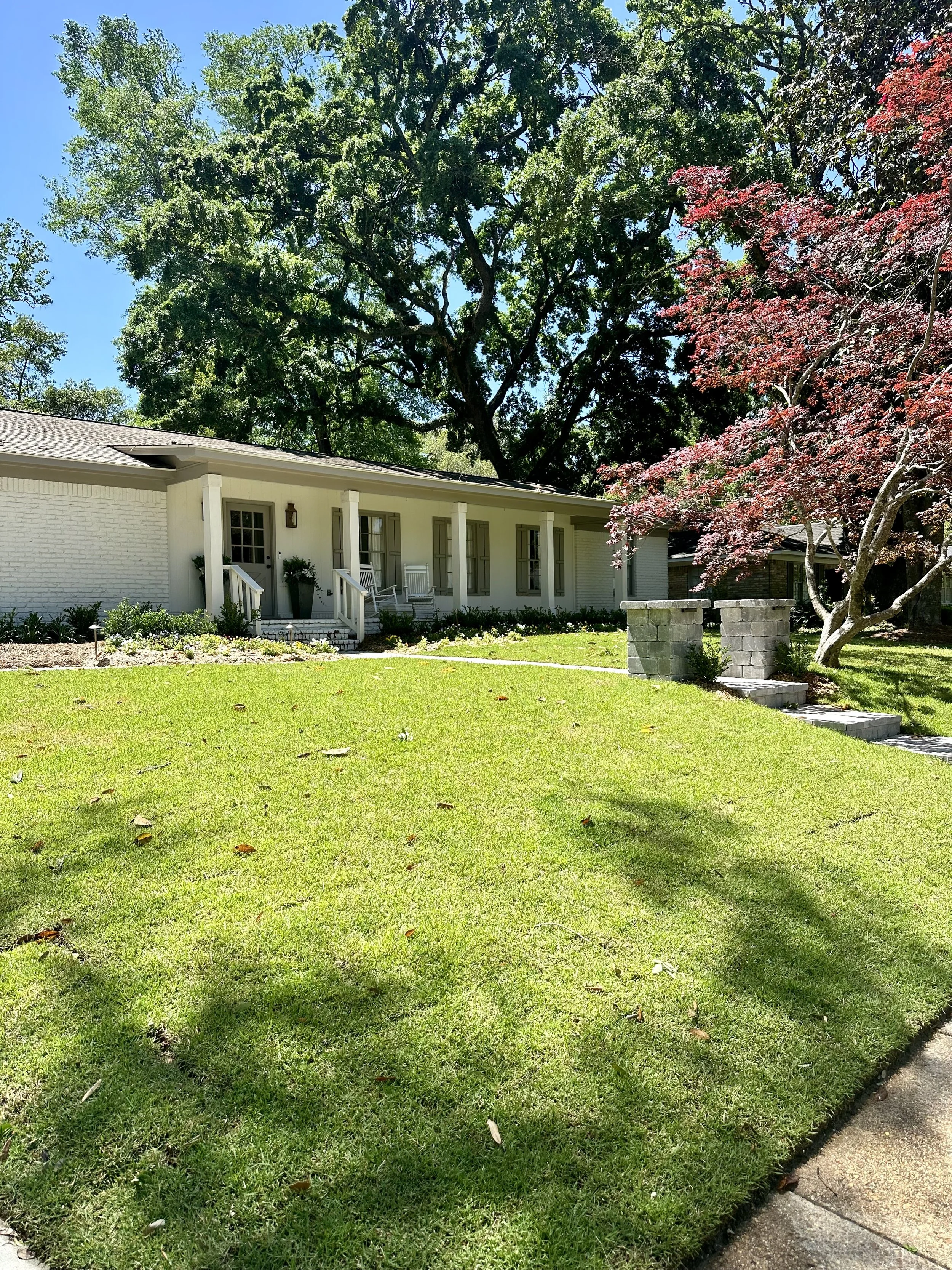 Well-maintained lawn and garden landscaping in a Southern-style home