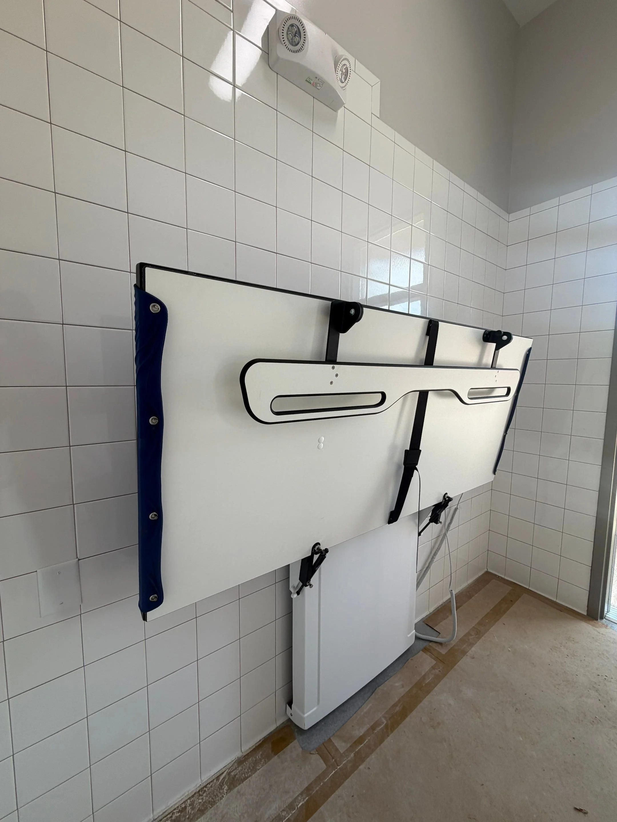 A powered changing table folded up to save space.