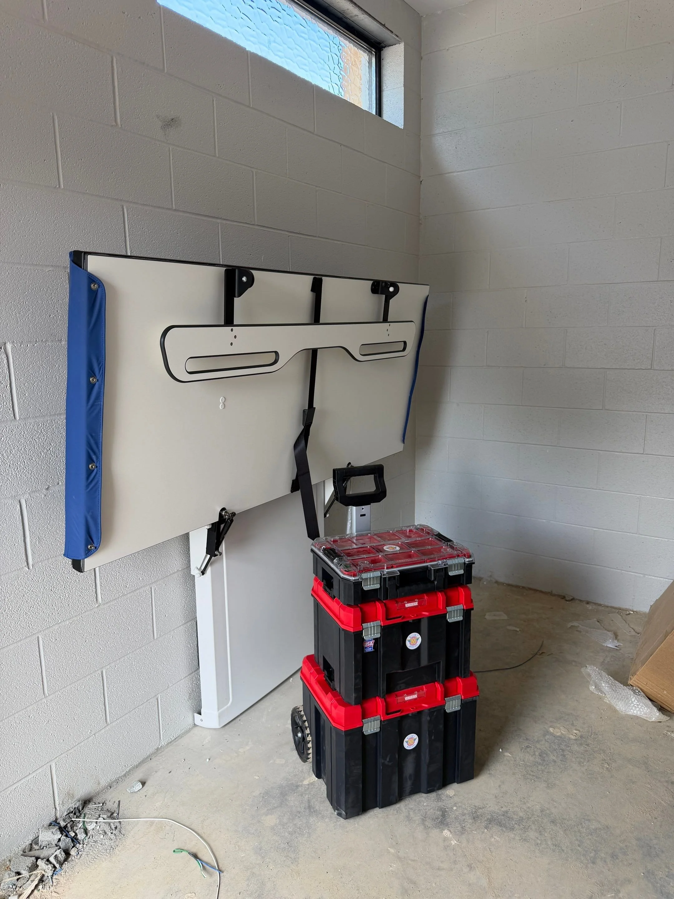 An in progress install photo of a powered changing table at Marvin Caldwell Park