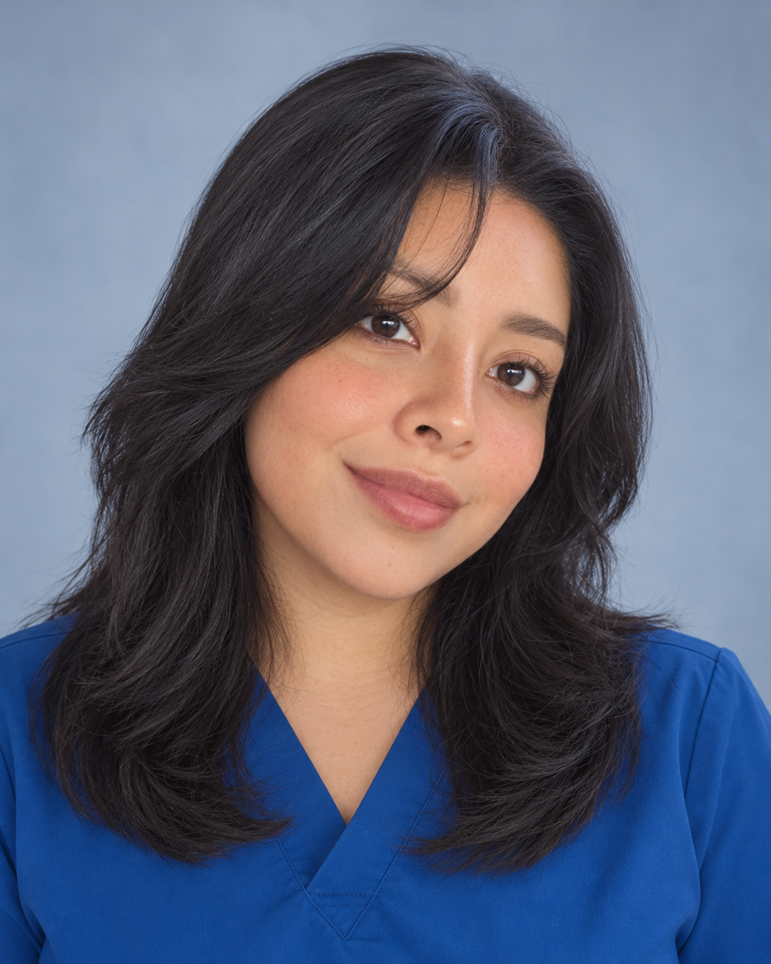 Dulce Lopez, medical assistant at EliteBio, wearing blue scrubs.