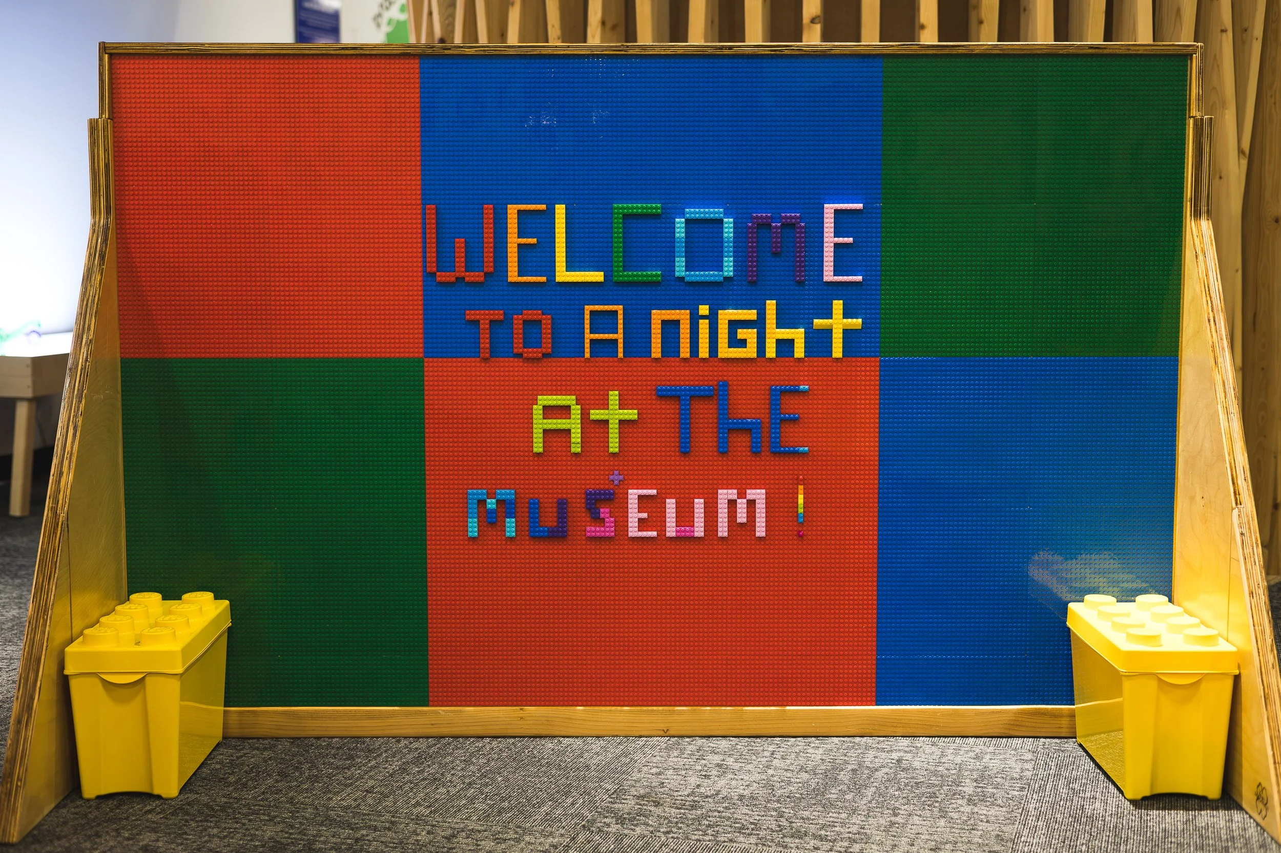 Lego wall that says "welcome to a night at the museum"
