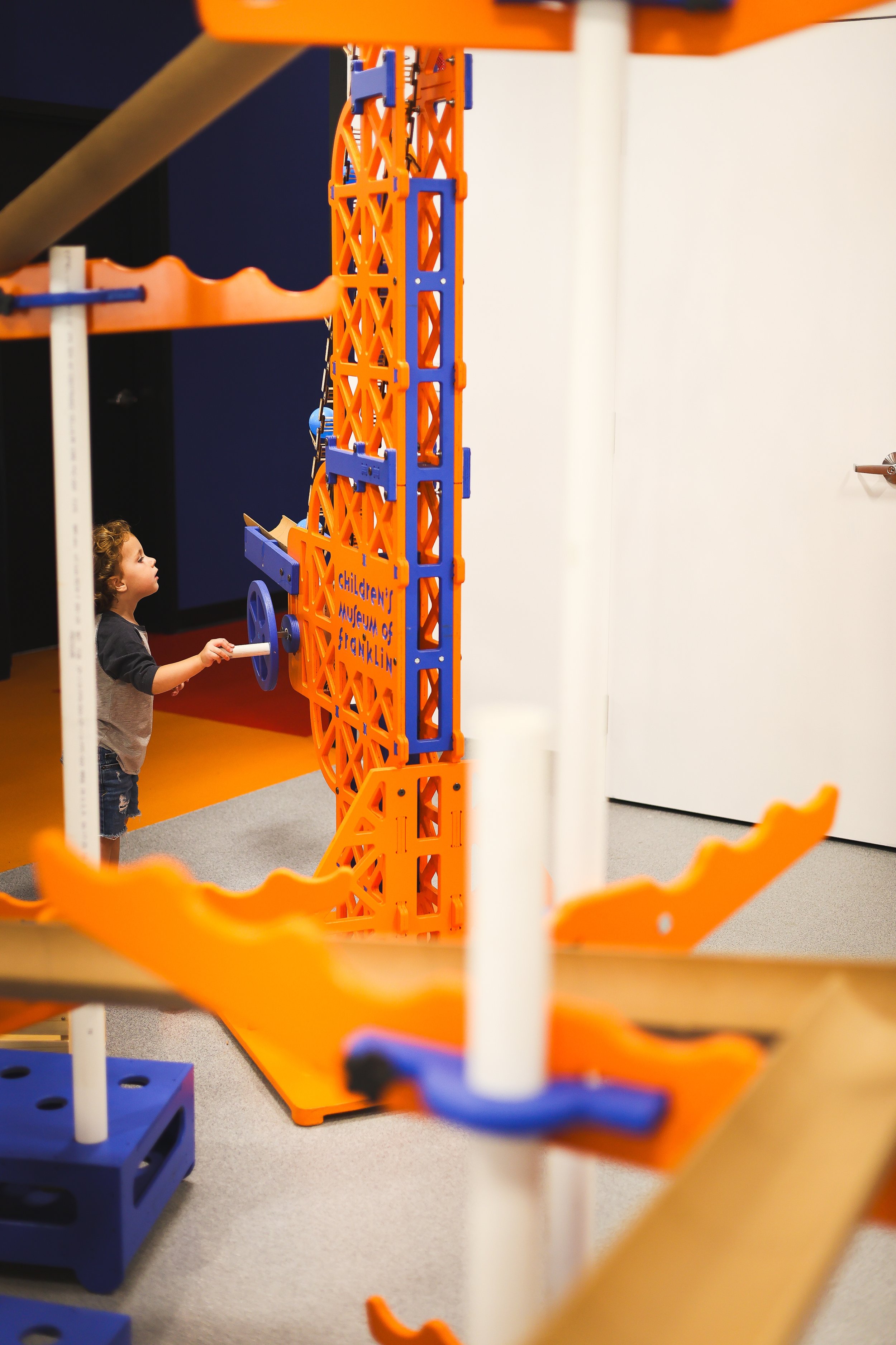 Child playing with engineering ball ramp