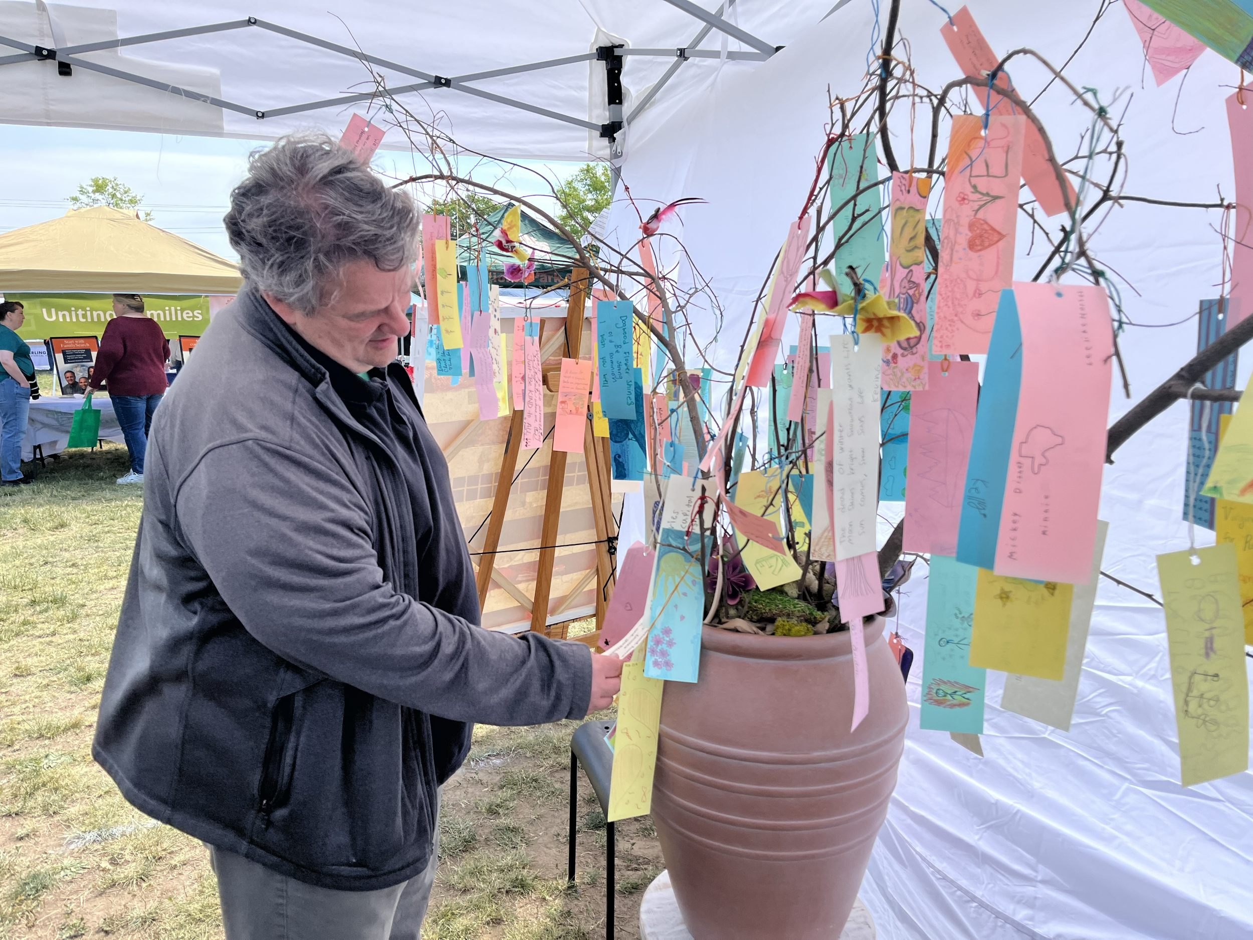 Delegate Alfonso Lopes checks out our PoeTree 2026 with over 110 haikus written by our Arlington community!