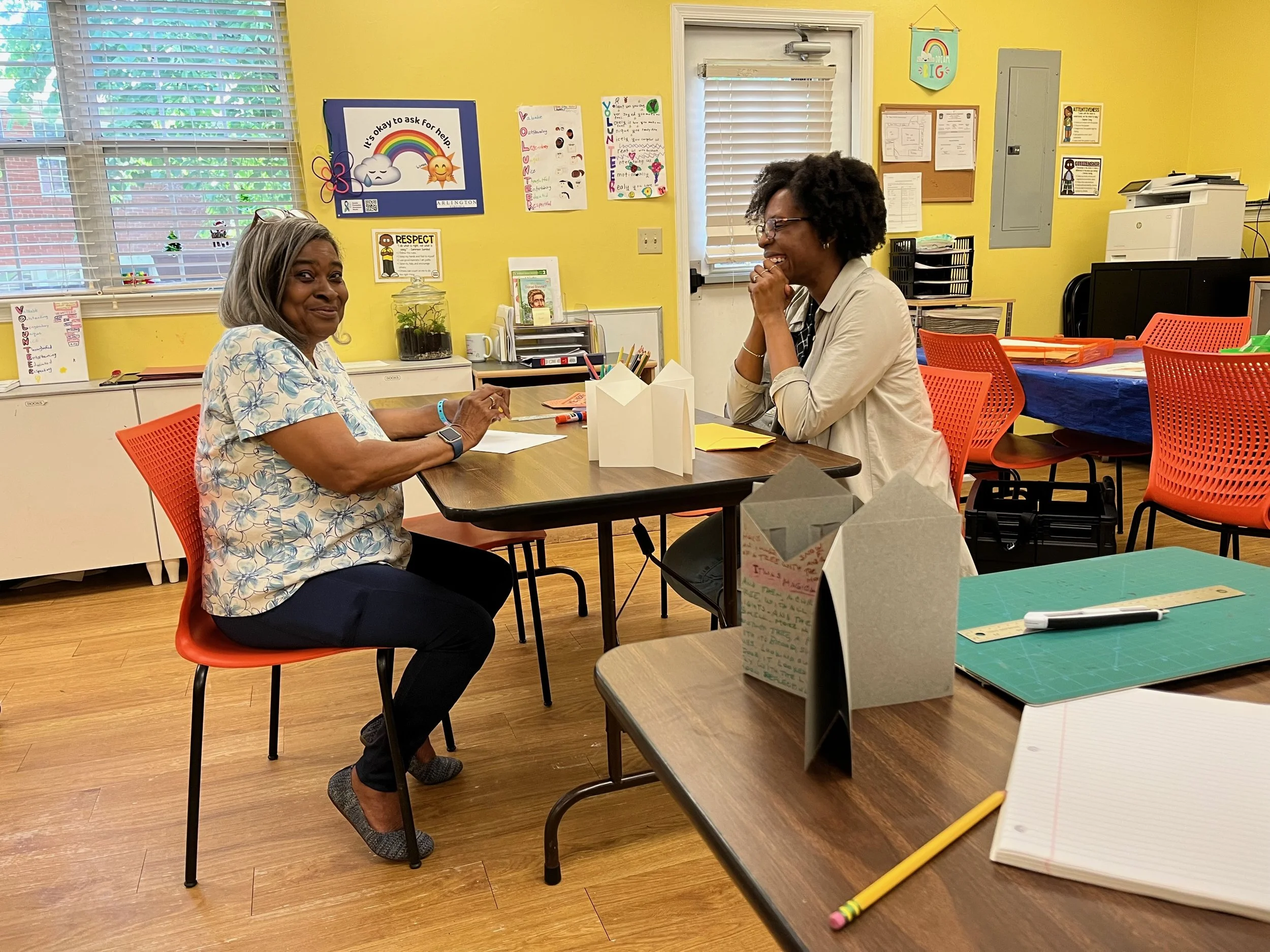Ms Gwen Day (left) resident of Fort Henry Gardens, discusses her story with Kori Johnson of the Studio PAUSE Team, at the Fort Henry Community Center, May 2025.