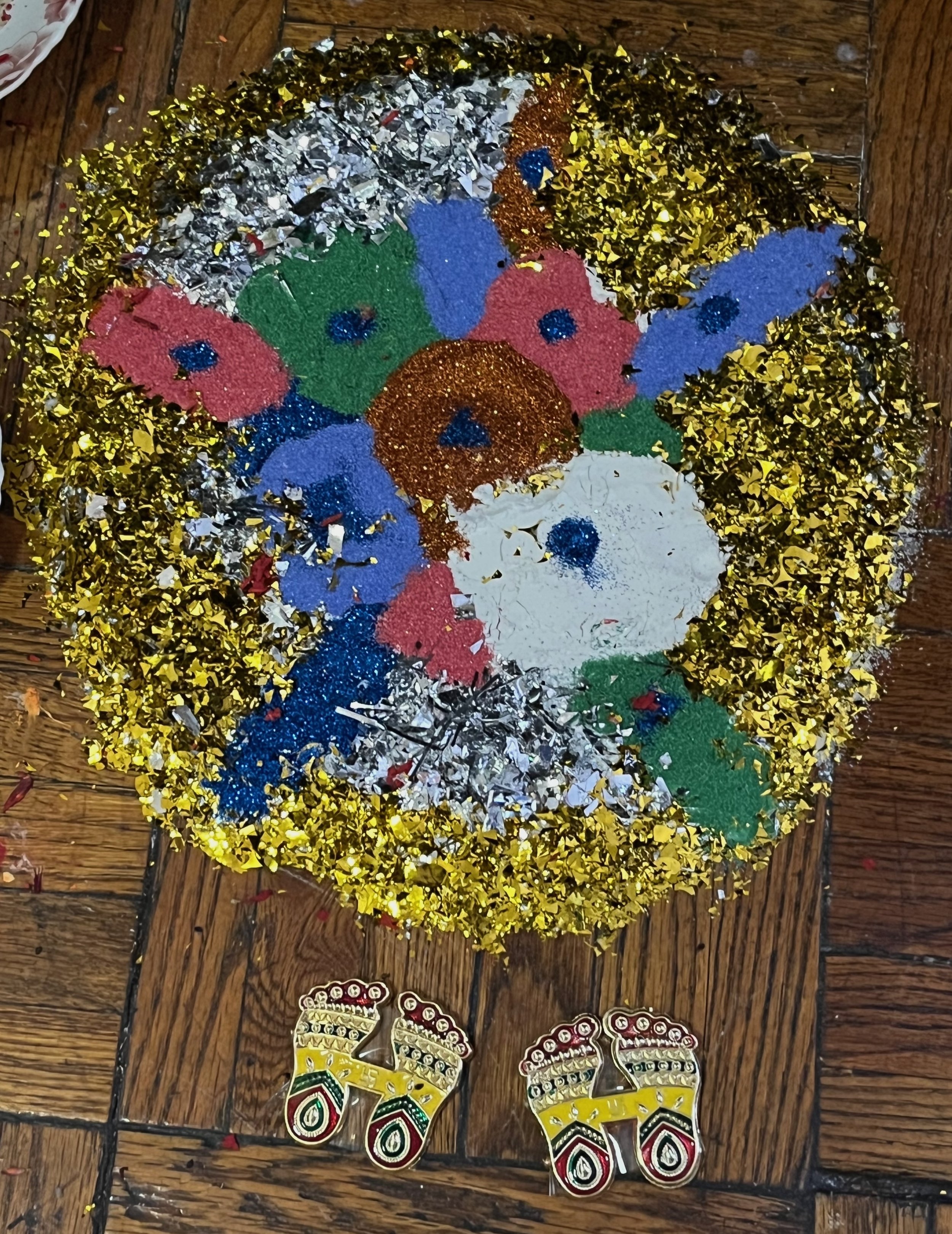 Our event started with a rangoli done by Sarita's husband at their home shrine, celebrating Lakshmi Puja. The feet of the goddess also appear in our book, as does the rangoli done by Sarita, Usha, and Deelasha in our studio in 2023