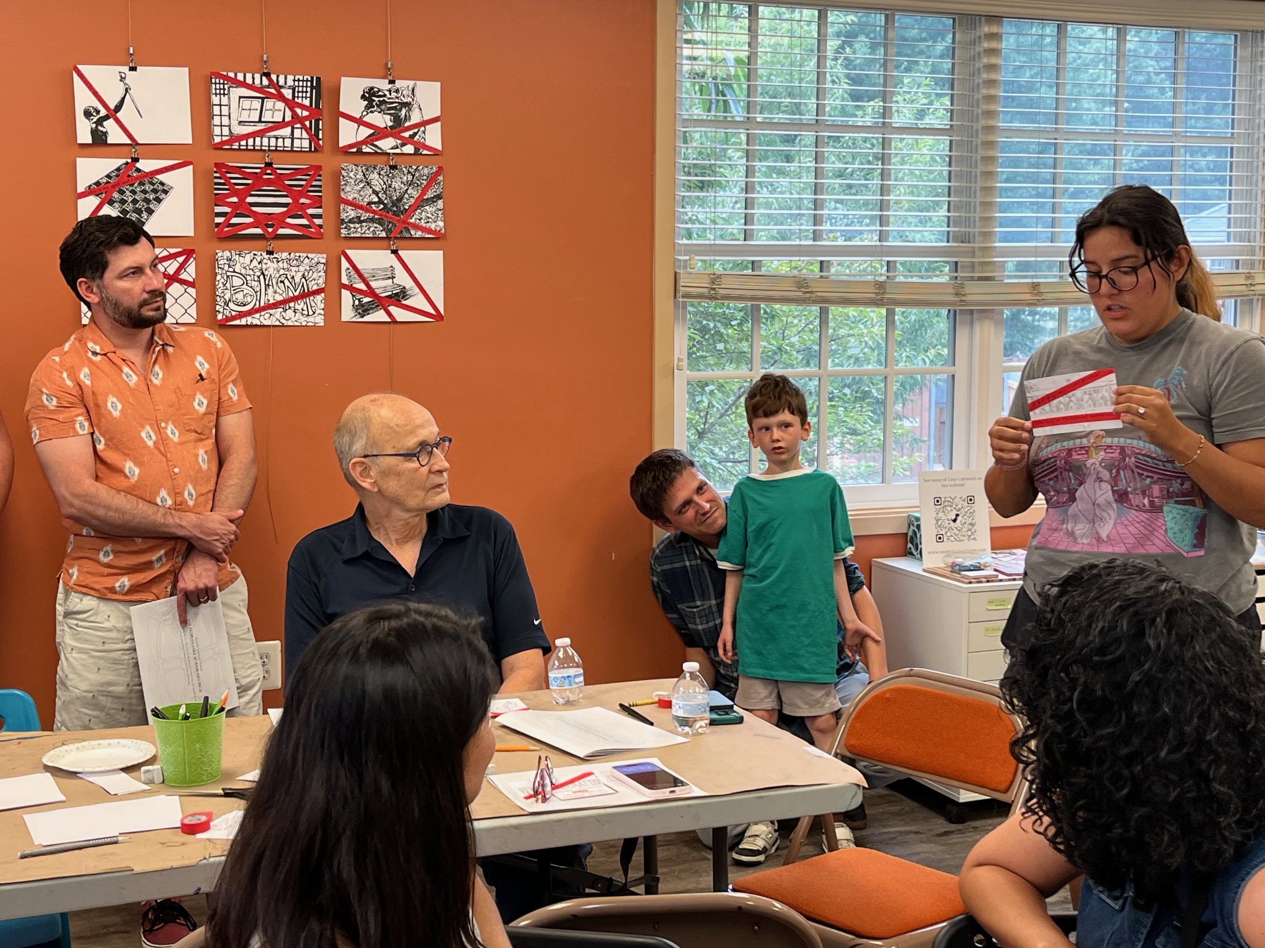 At the reception for Angelina's exhibit, Sarah Manrique Chiriboga shares her drawing of The Arches at Barcroft Apartments, where she loved to play as a child