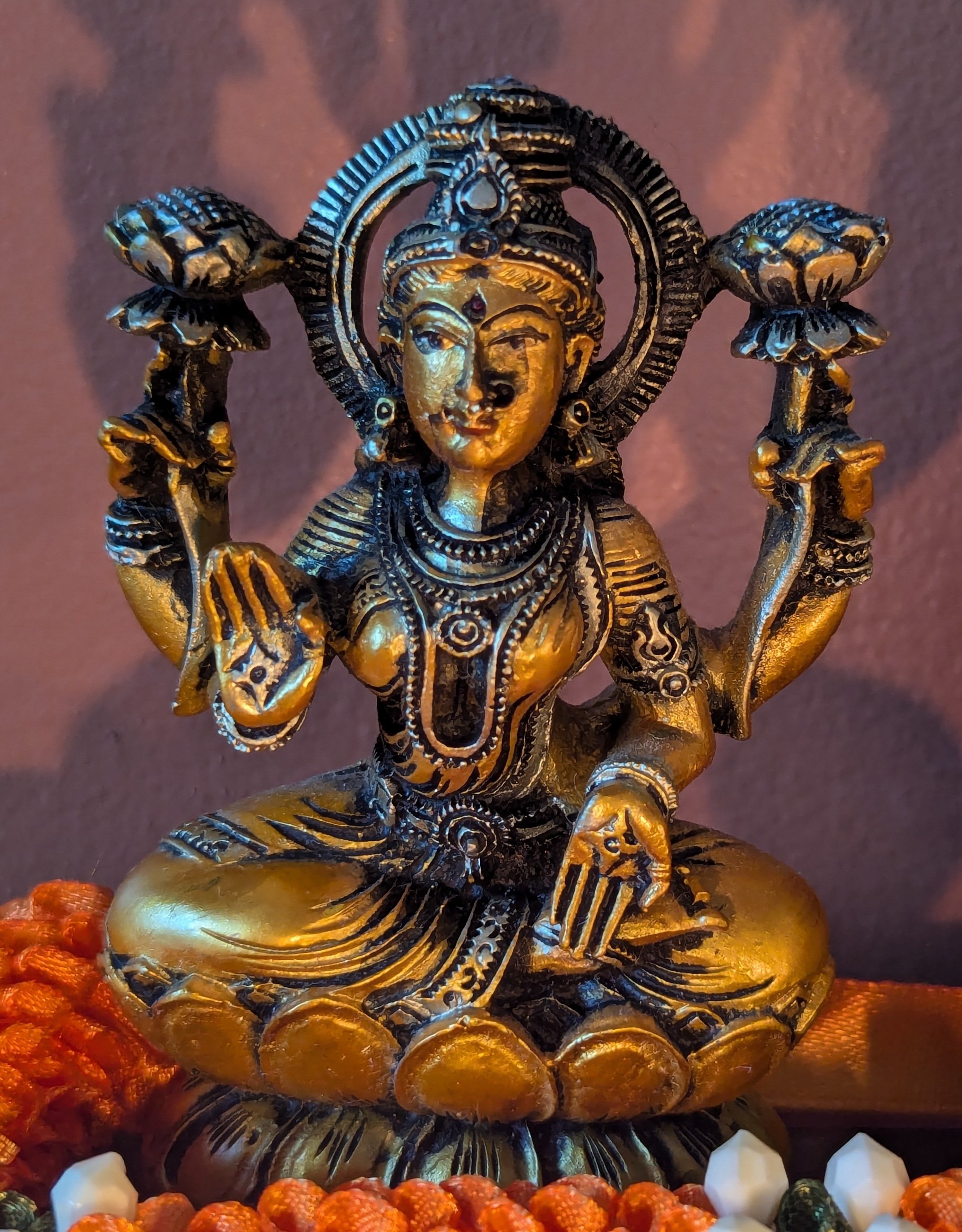 Close-up of Lakshmi from a sculpture I call the Mumbai Triad, where Ganesha, the elephant-headed god is in the center, Lakshmi is on his left, and Saraswati is on his right. My mother gave me this when I opened my studio.