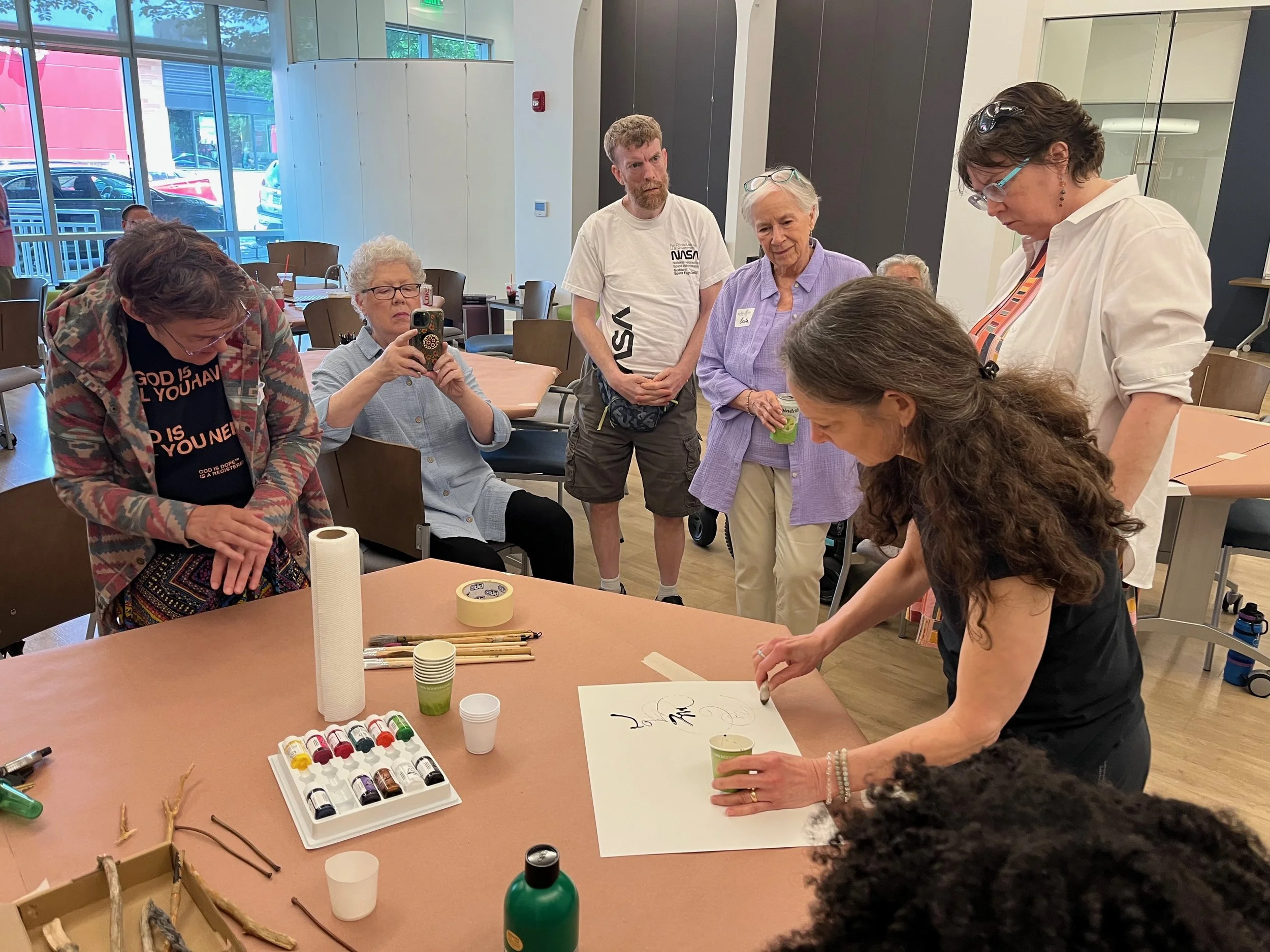 Artist LouLou Marino does a demo of how she responds to music with her mark-making. She used natural found objects like pebble and twigs with black ink to make her art. Abby played the song "Remember Me" from the movie Coco, which was the inspiration