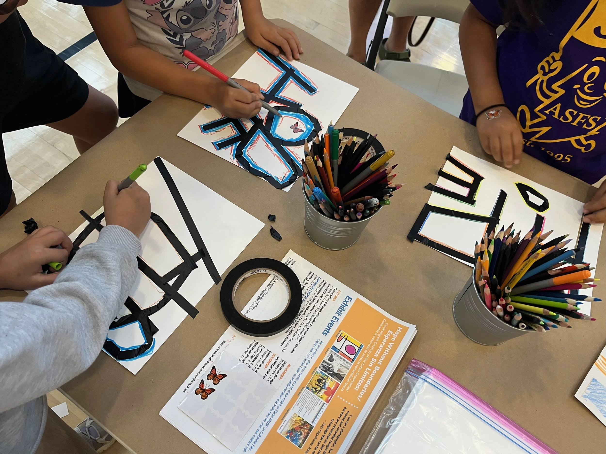 Children working on the activity based on Victor Hurtado's artwork "Hope Without Boundaries"