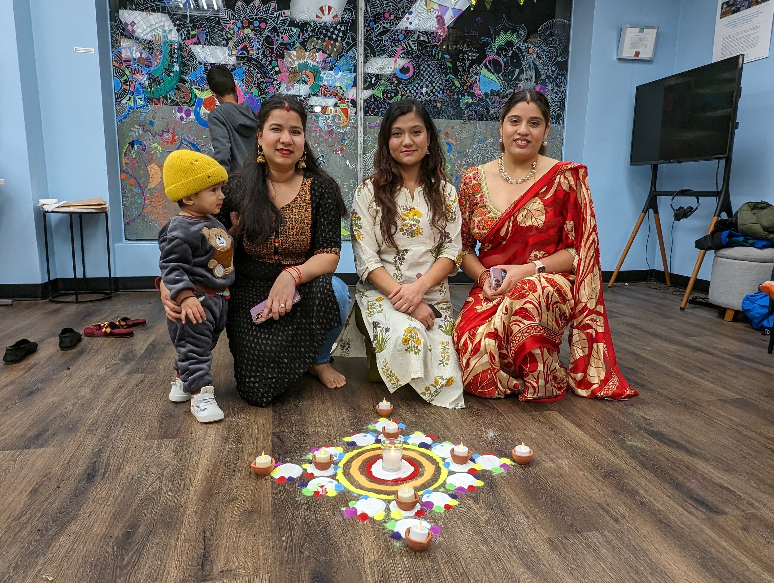 Sarita Regmi and her friends Usha and Deelasha created a rangoli at the Studio to celebrate Diwali 2023. The friends are all from Nepal and had fun creating this impromptu design on the floor using colorful sand while the rest of us watched. We learn
