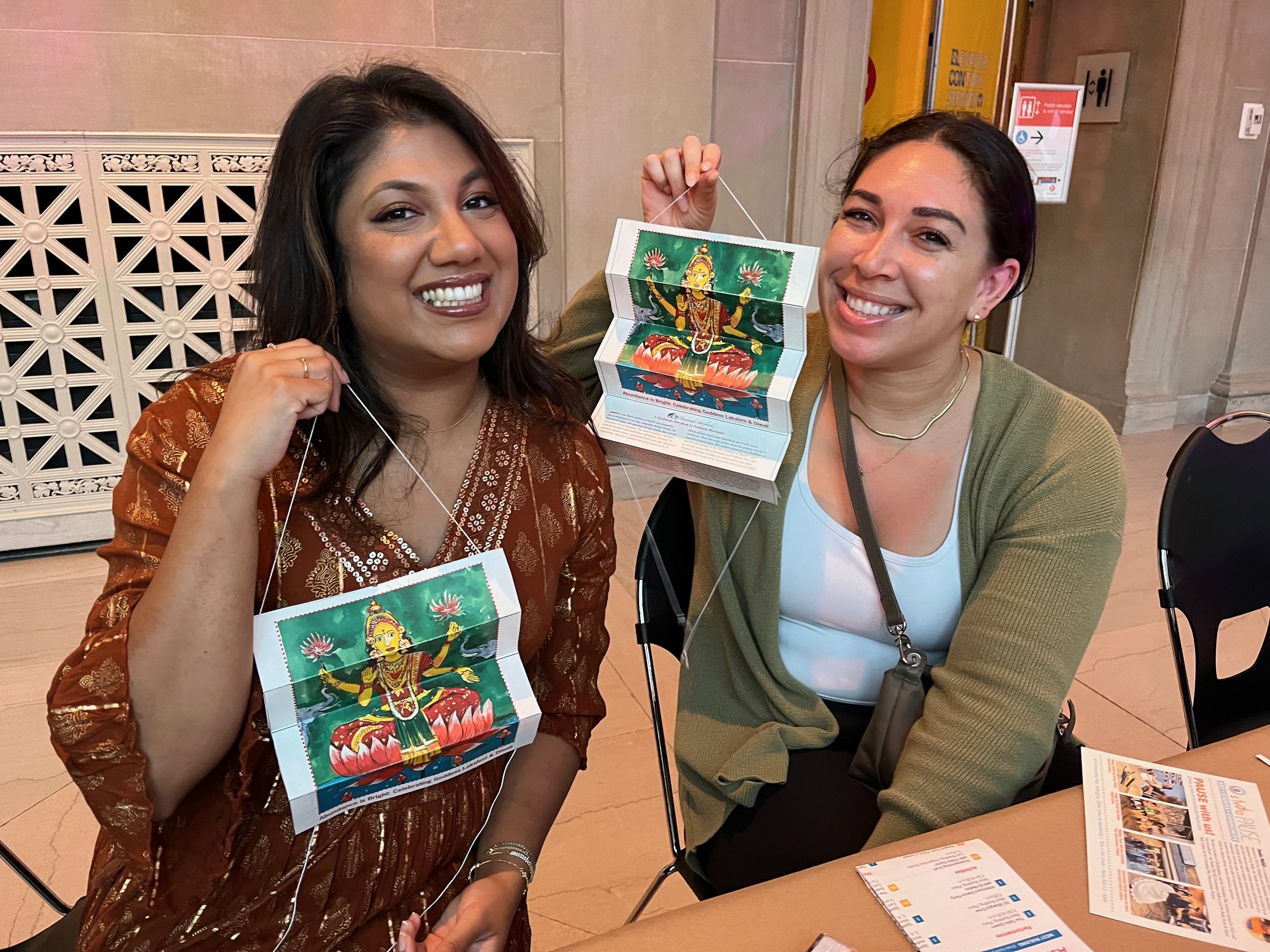 Friends displaying their open accordion books. When I showed these photos to Sadye, who works at the Goodwill next to the studio, she said that the woman on the left was her friend and she had told her about me. And she was going to her diwali party