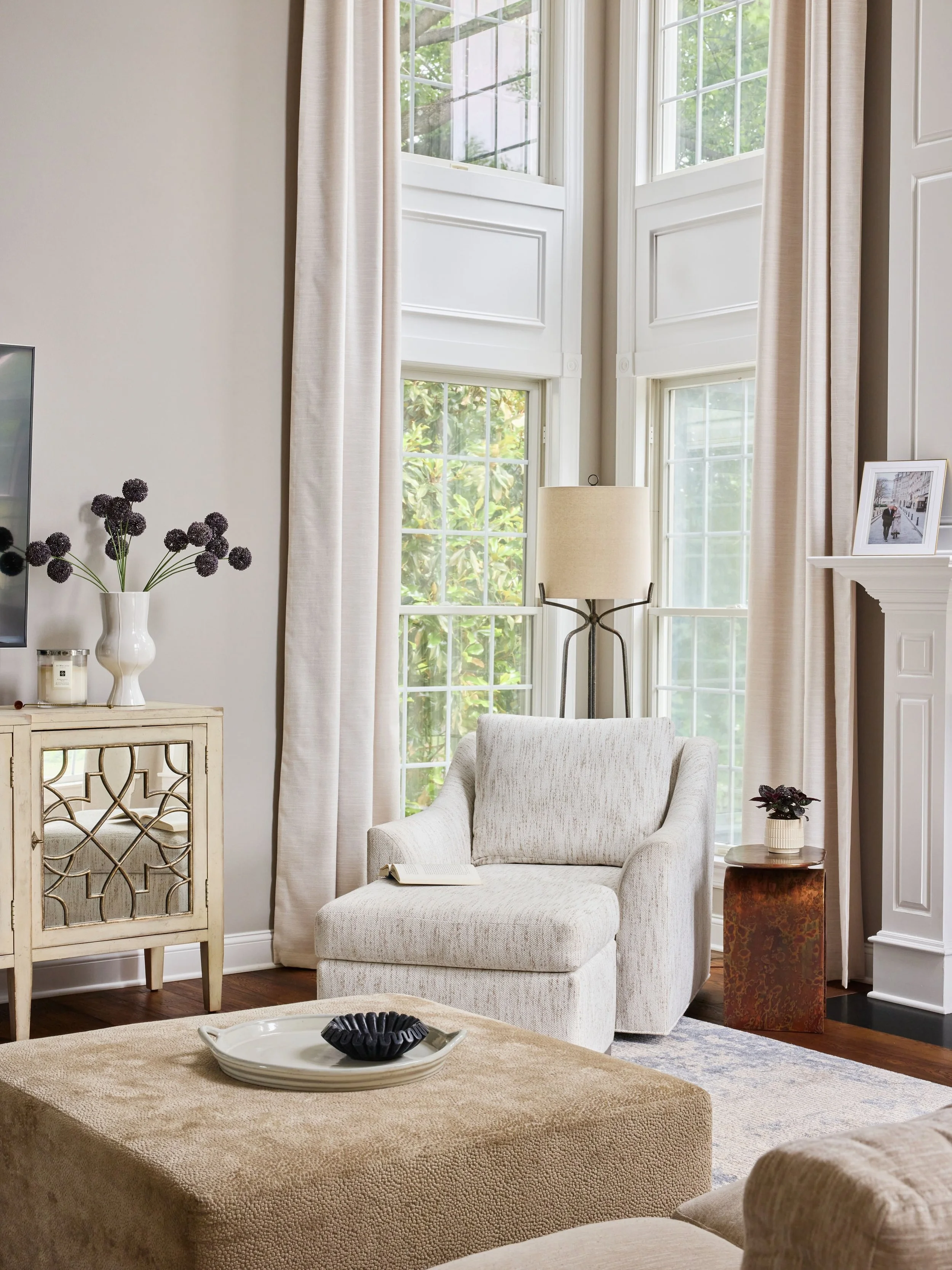 If there&rsquo;s room for an ottoman, I&rsquo;m probably adding the ottoman.

The tall windows and ceilings called for a chair with a little more presence. We paired it with an ottoman to make the spot genuinely comfortable&mdash;somewhere to read, p