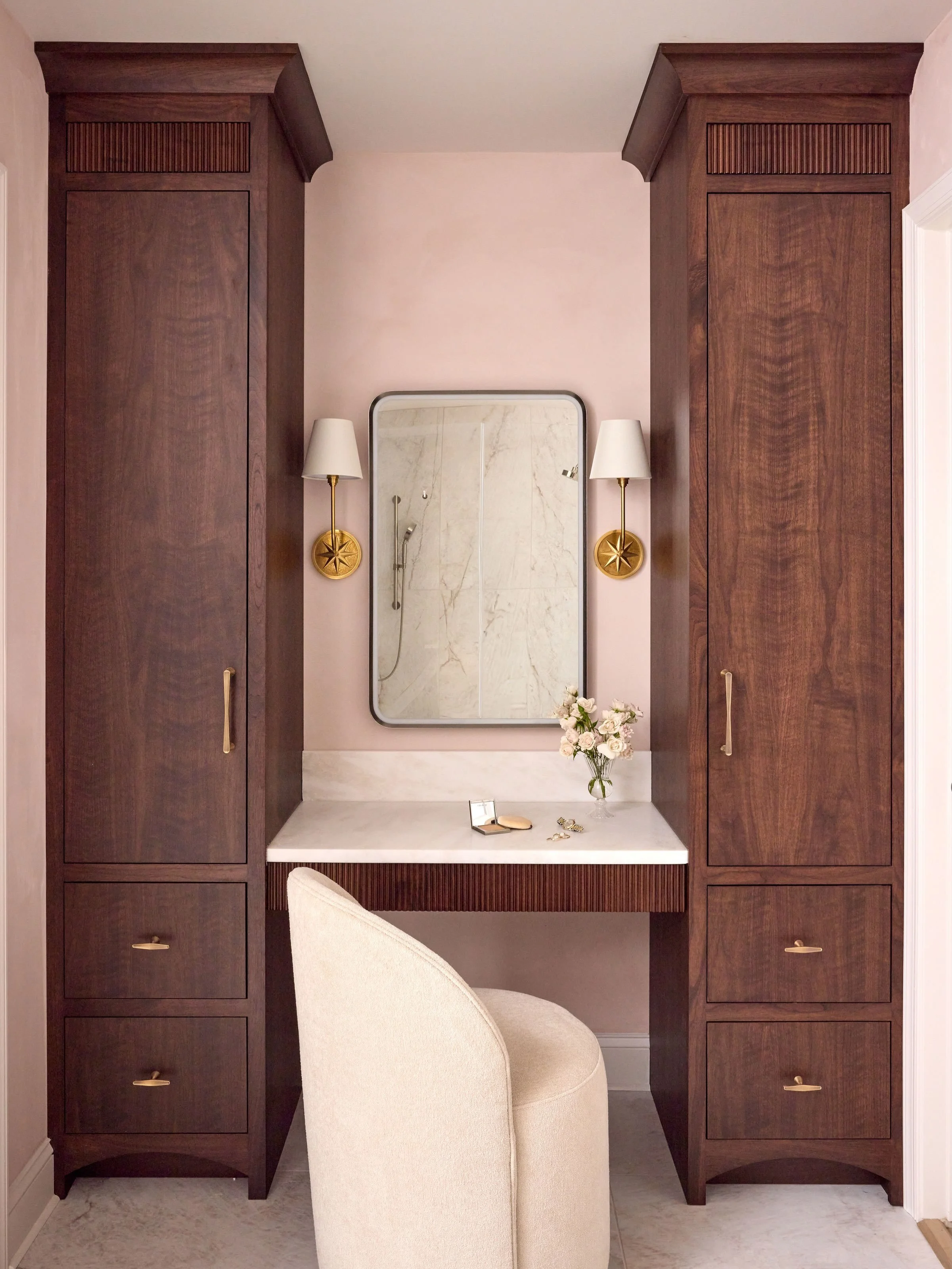 For the master bathroom renovation, we worked with our carpenter to design custom cabinetry, including a dedicated makeup vanity with integrated hot tools storage and push out drawers hidden in the reed detail. 

Design @curate_interior_designs 
Phot