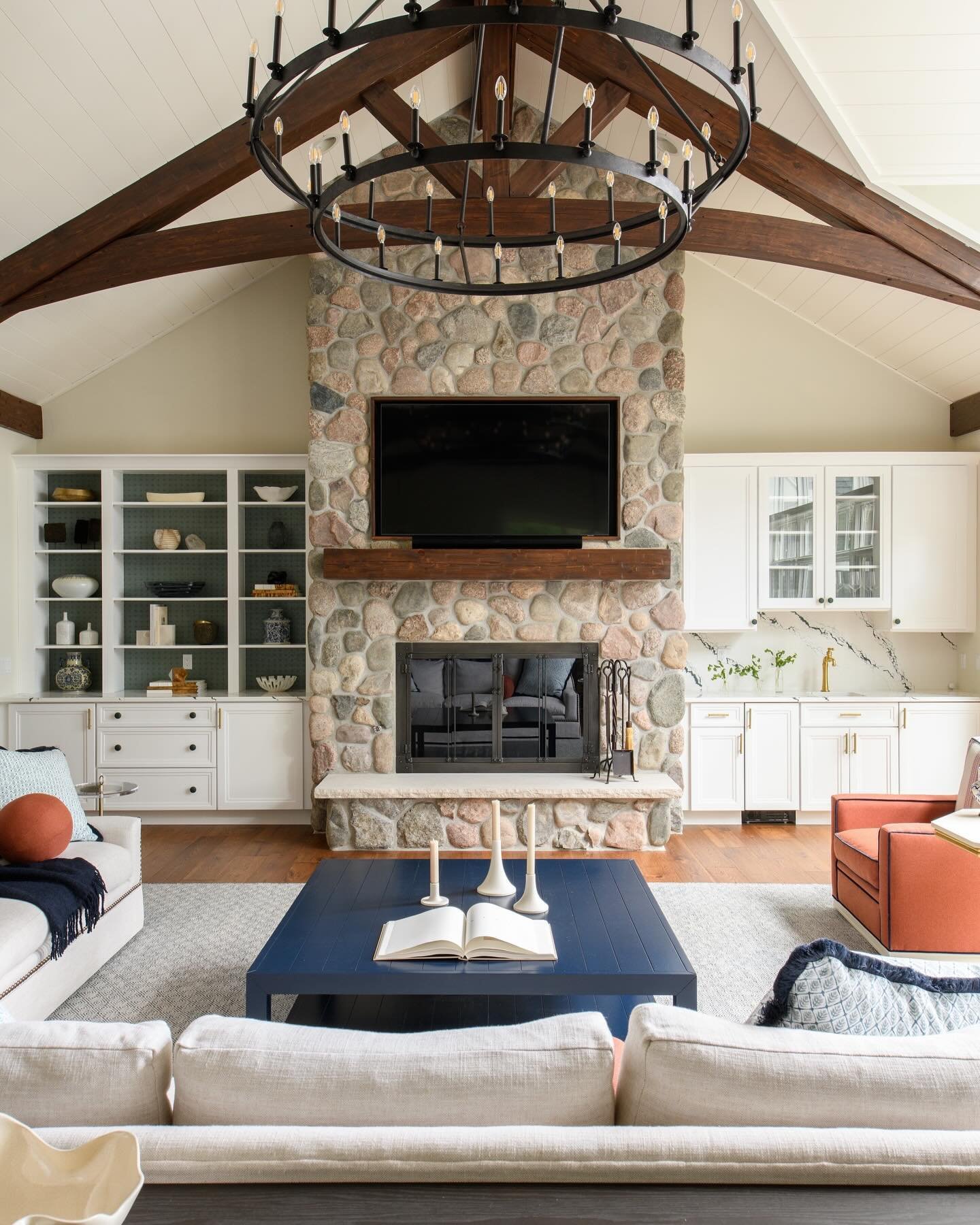 Rustic elegance meets colorful style in this lake house great room. Our client loves bold color and we enjoyed incorporating it into their home. 

In this spacious great room, you&rsquo;ll notice how the deep blue coffee table, coral upholstered chai