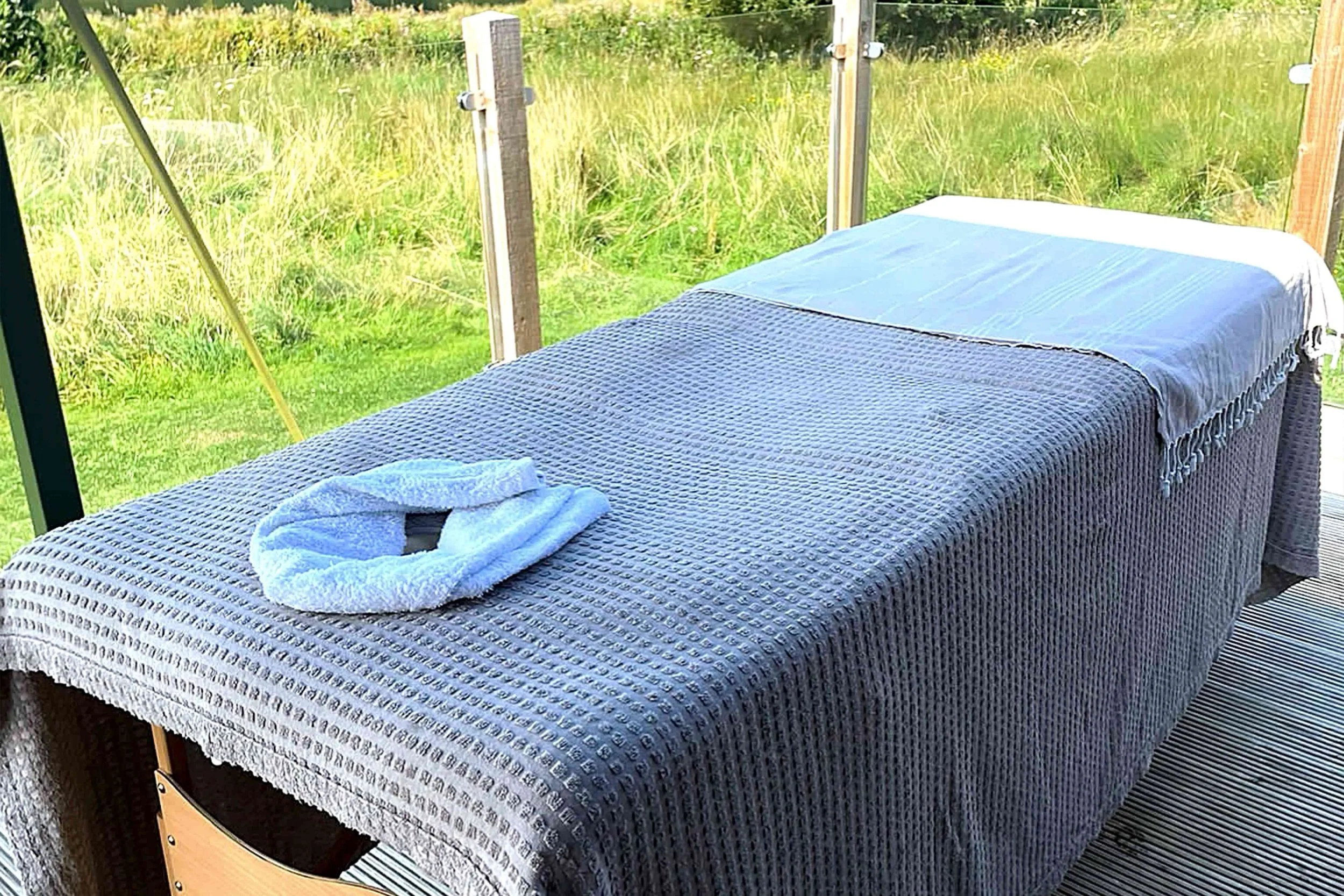 An image of a massage table on the deck of a Nest lodge