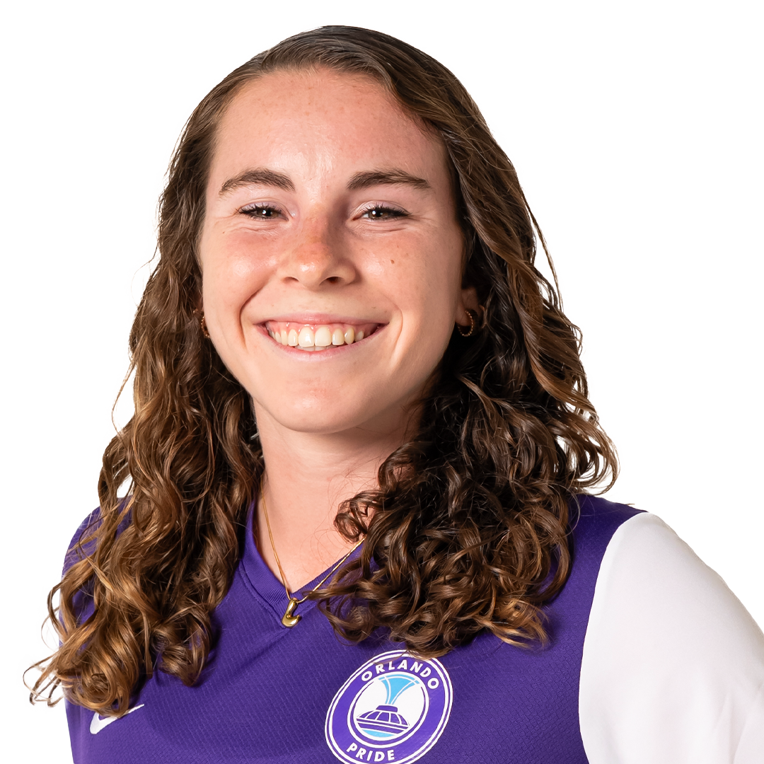 A young woman with brown curly hair, smiling, wearing a purple sports jersey with the Orlando Pride logo.