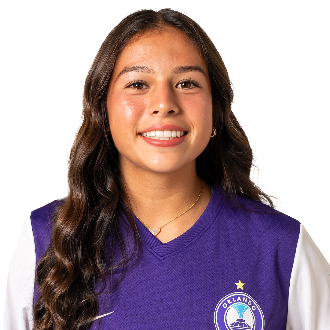 Young woman wearing Orlando soccer jersey smiling at the camera.