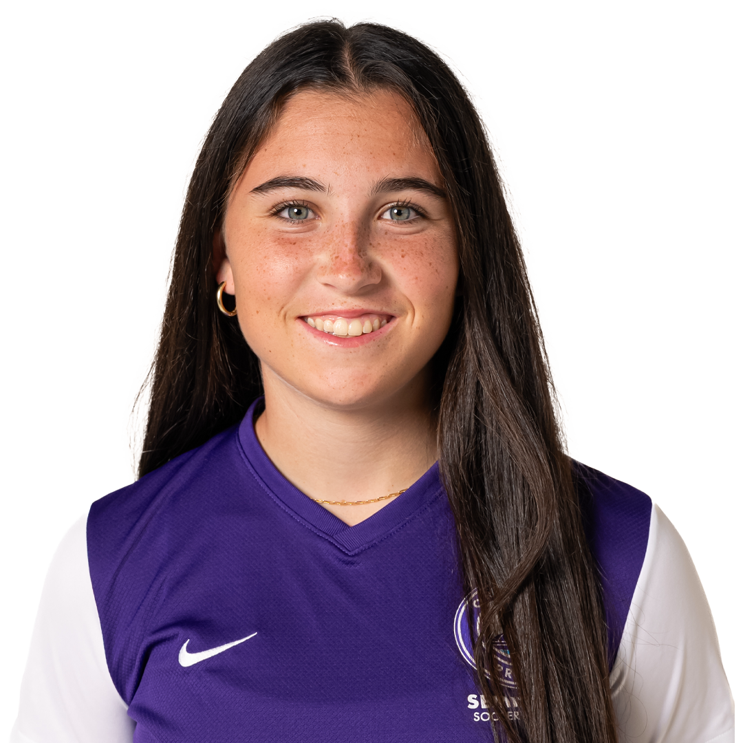 A young woman with long brown hair, wearing a purple and white Nike sports jersey, smiling at the camera.
