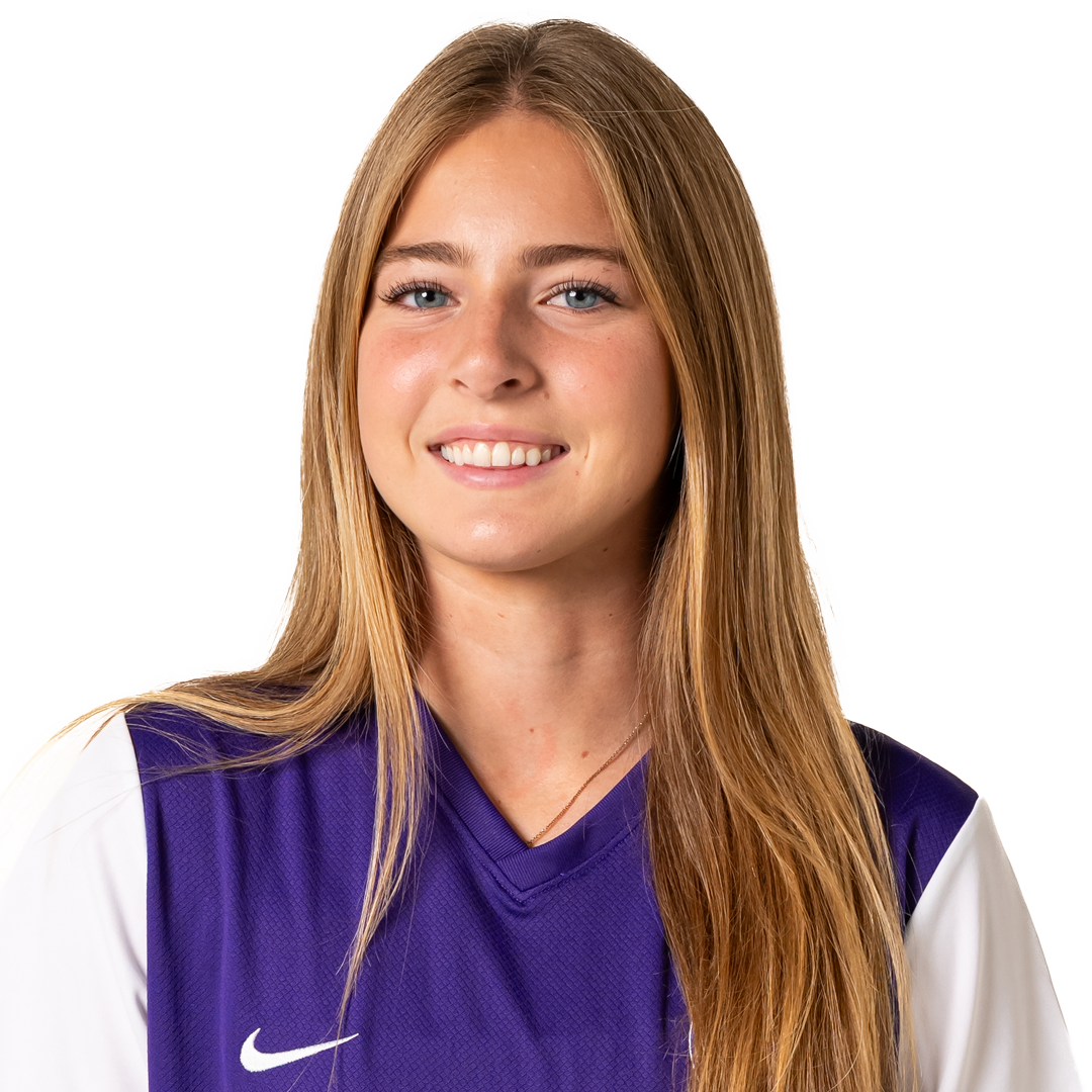 A young woman with long blonde hair, blue eyes, and light skin, smiling, wearing a purple sports jersey with white sleeves and a Nike logo.