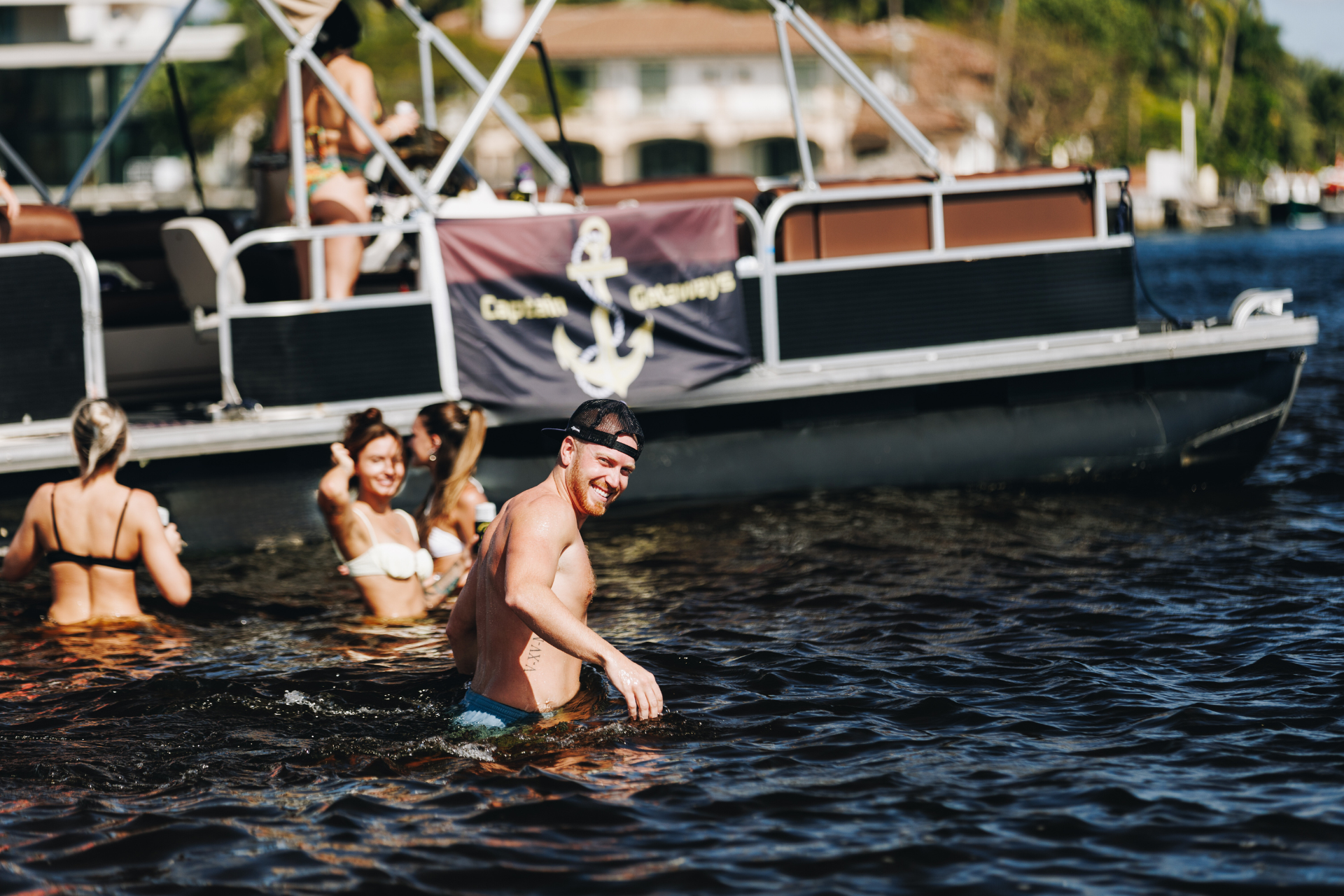 Laughing in water on a boat charter at Fort Lauderdale Sandbar.