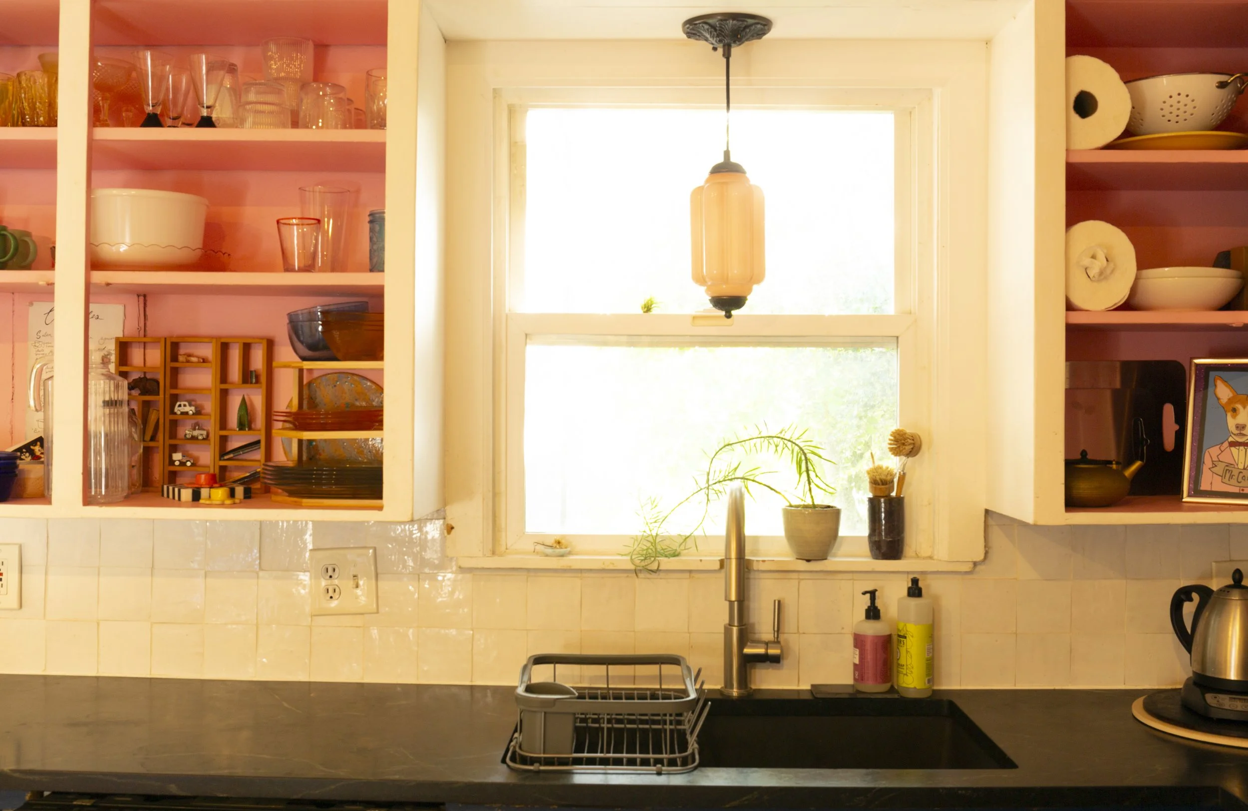kitchen sink and pink cupboards